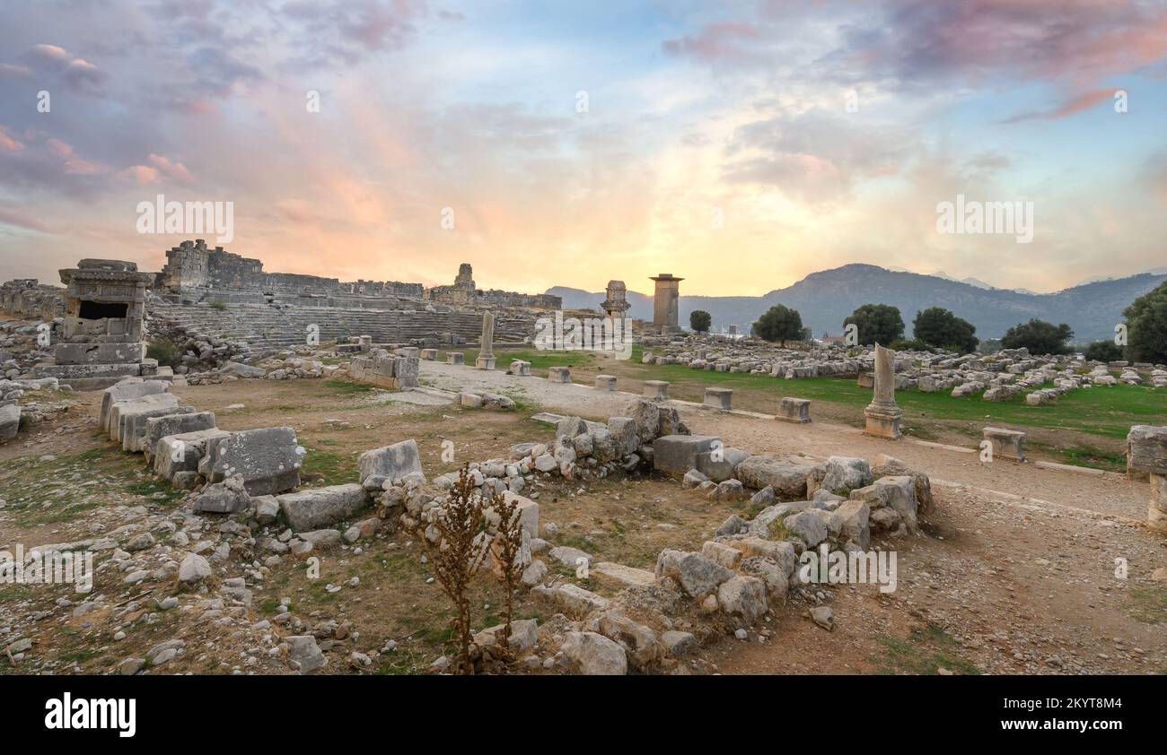 Xanthos Ancient City. Grave monument and the ruins of ancient city of Xanthos - Letoon in Kas, Antalya, Turkey at sunset. Capital of Lycia. Stock Photo