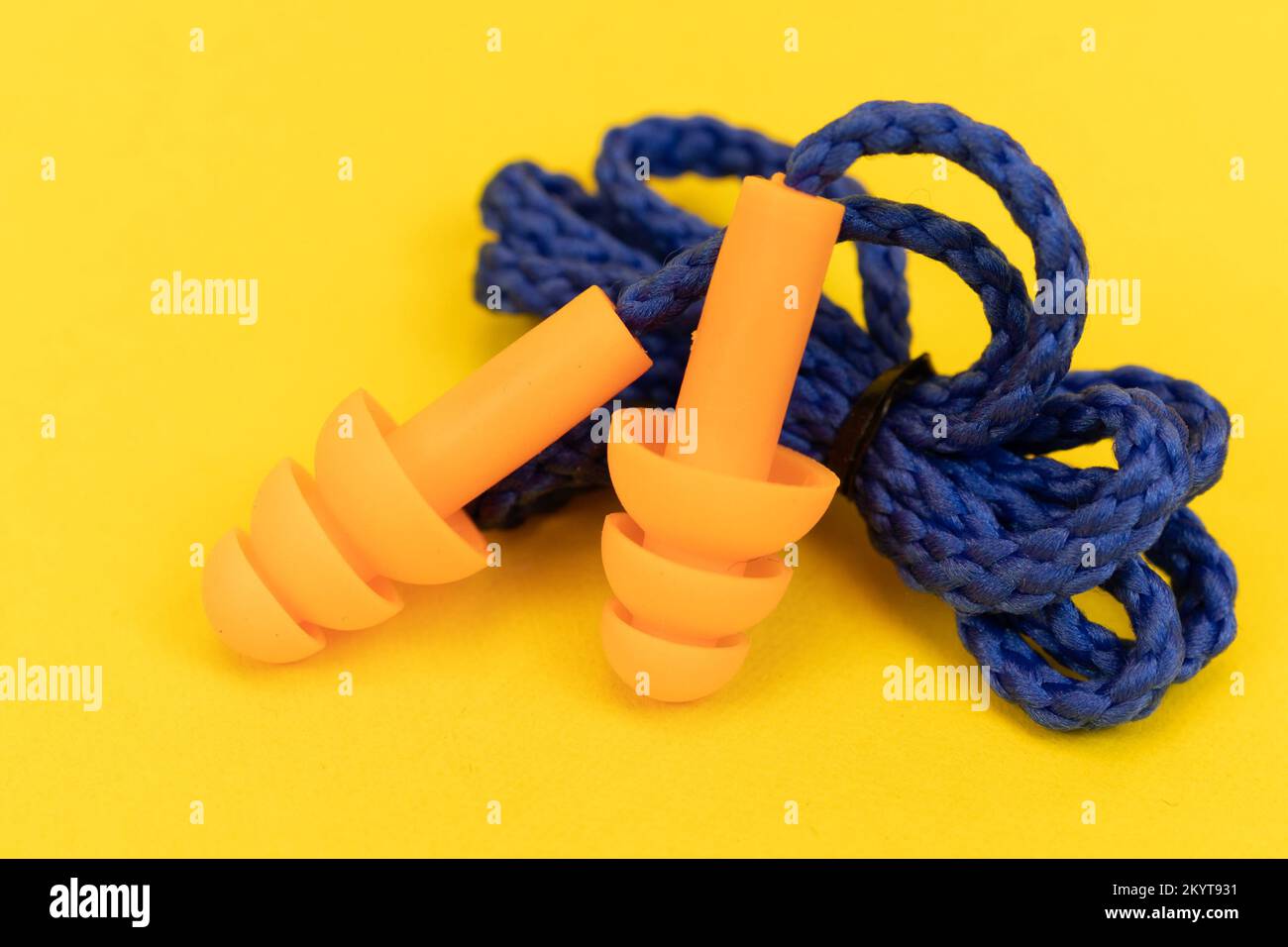 Silicone ear plugs for human ears on yellow background Stock Photo - Alamy