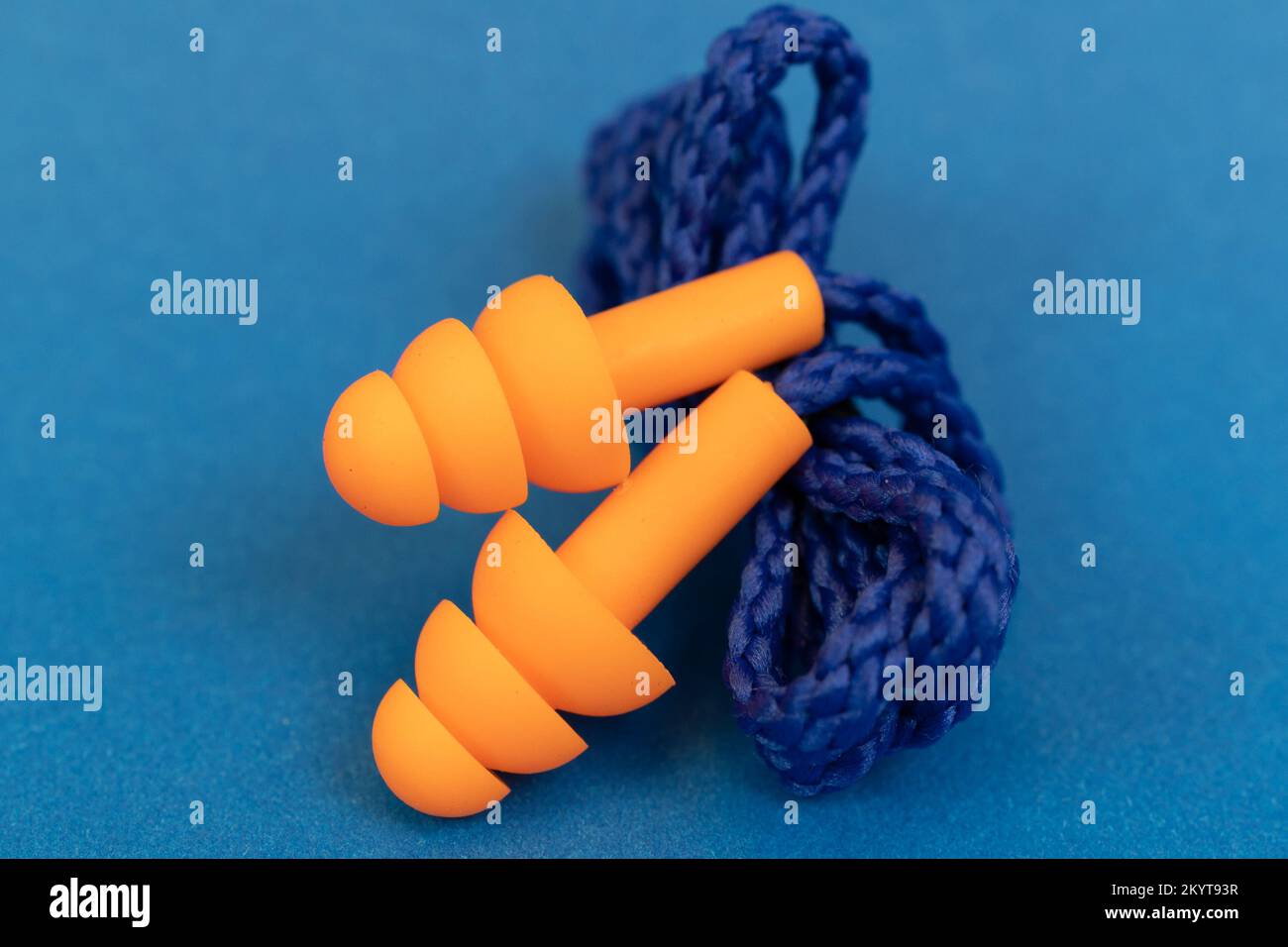 Silicone ear plugs for human ears on blue background Stock Photo - Alamy
