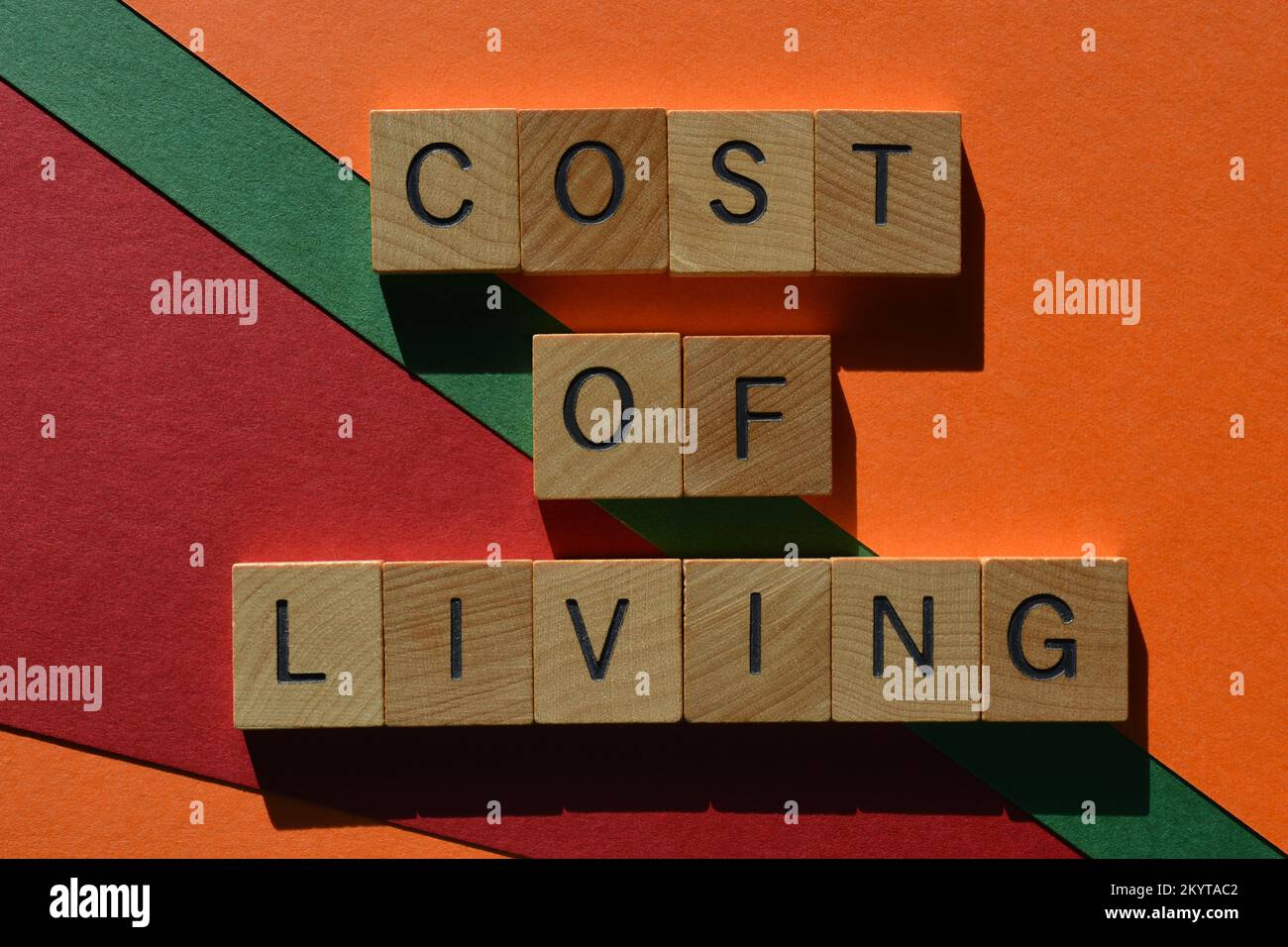 Cost Of Living, words in wooden alphabet ketters isolated on red, green