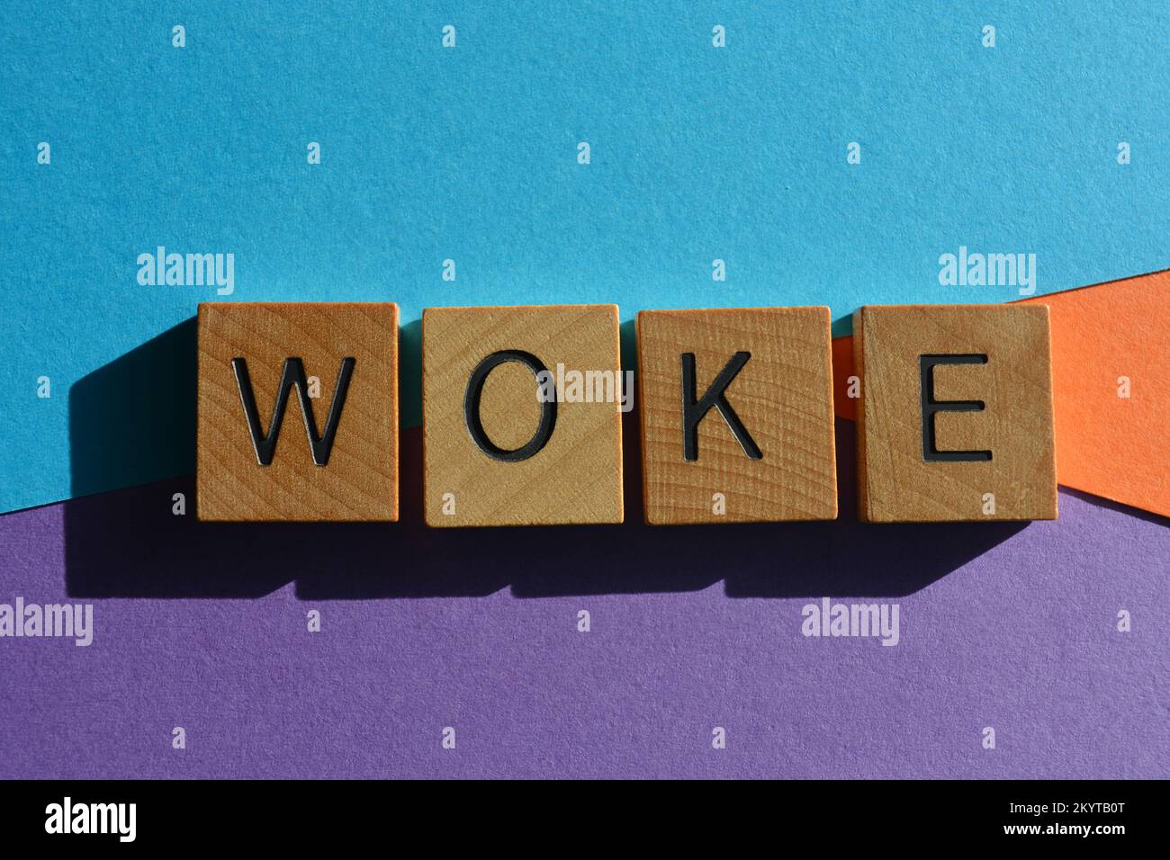 Woke, word meaning to be alert to injustice in society in wooden alphabet letters isolated on background Stock Photo
