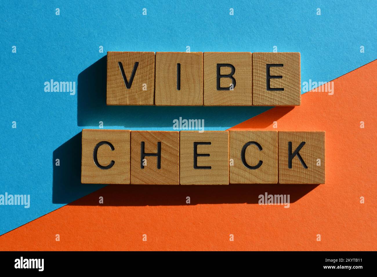 Vibe Check, Get Z buzzword meaning an evaluation of someones emotional state in wooden alphabet letters isolated on bright background Stock Photo