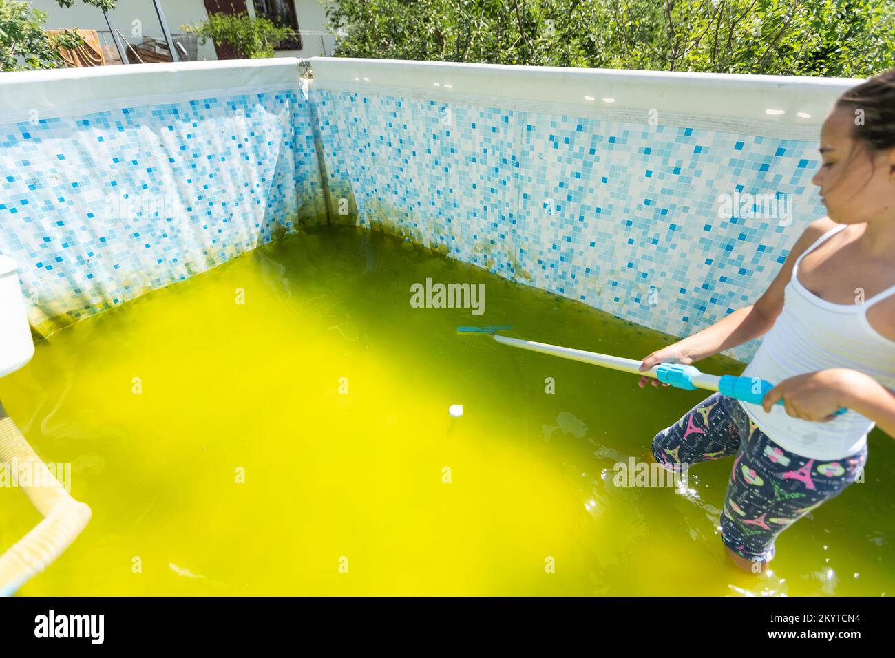 a little girl cleans a very dirty pool Stock Photo Alamy