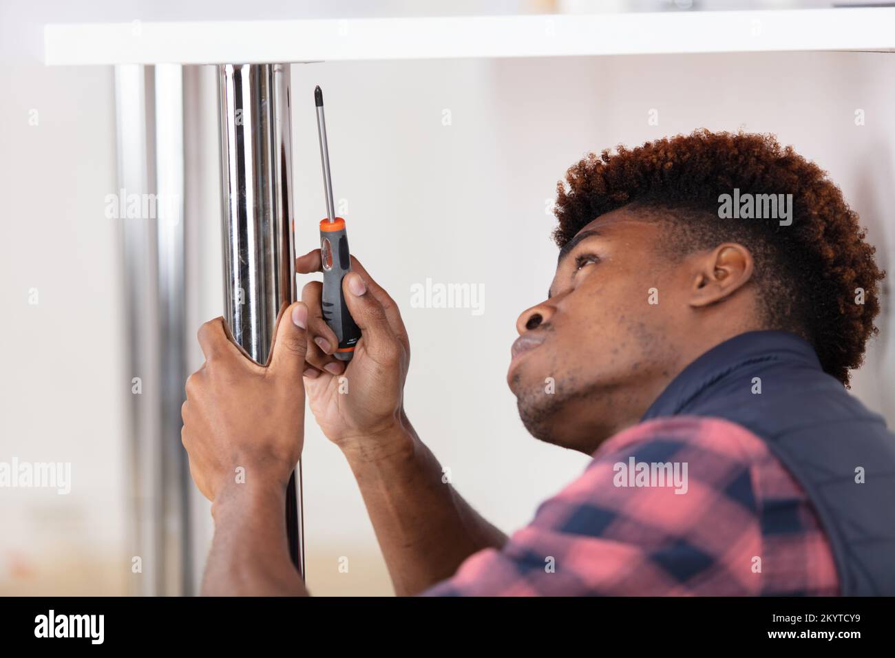handyman fixing kitchens with screwdriver Stock Photo Alamy