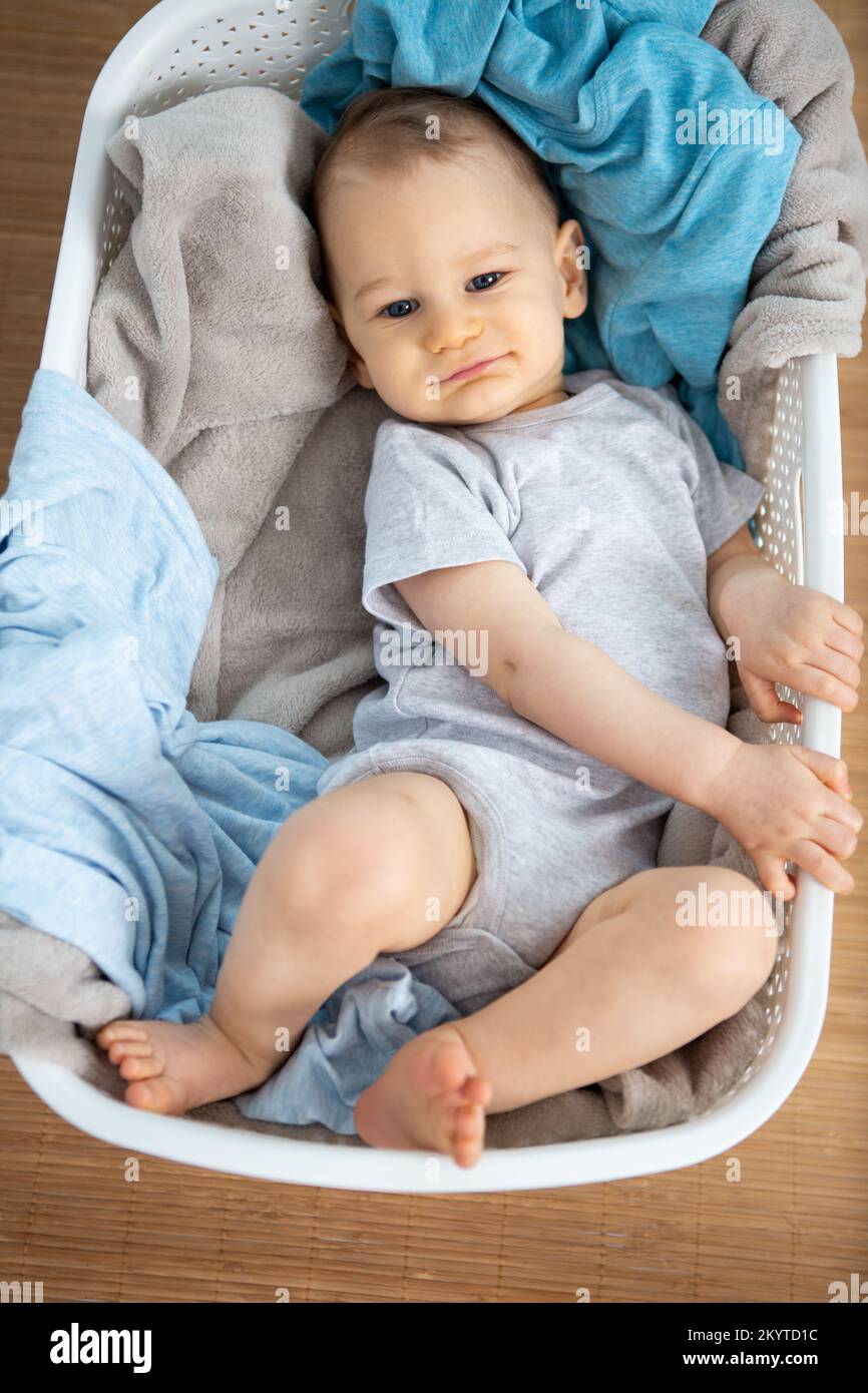 a baby in laundry basket Stock Photo Alamy