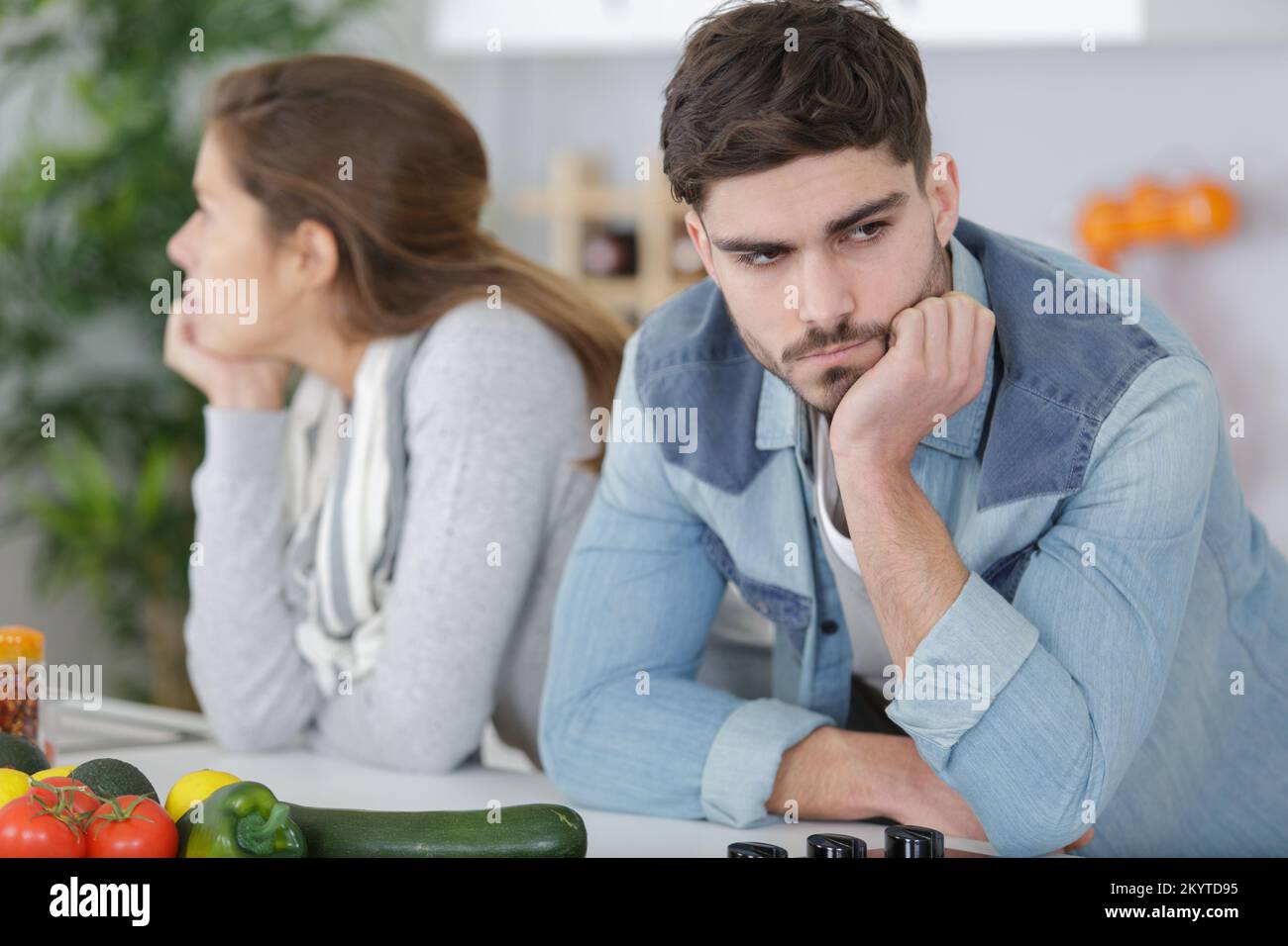 couple in kitchen ignoring each other after an argument Stock Photo