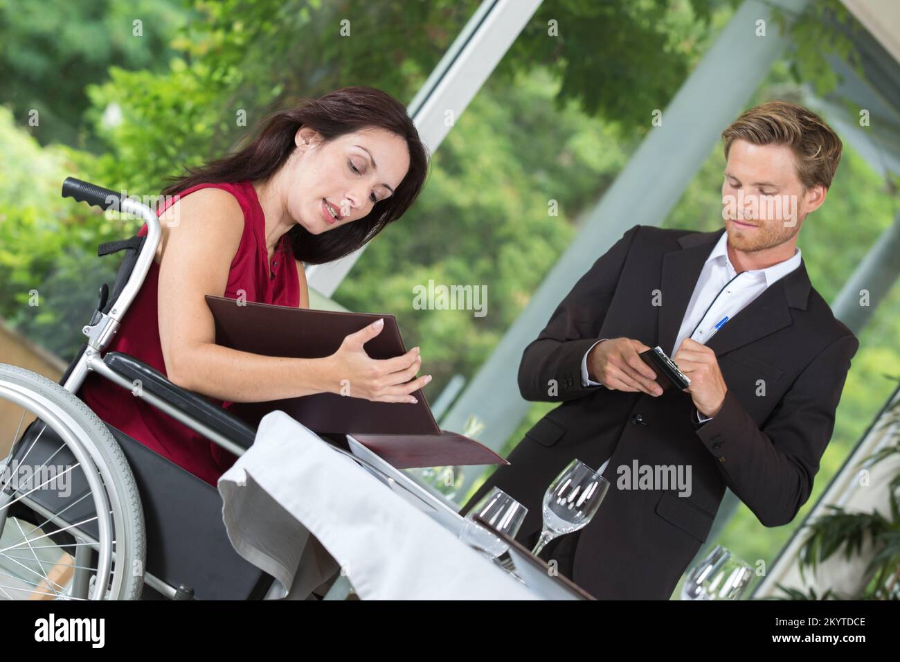 handicapped restaurant client ordering her food Stock Photo - Alamy