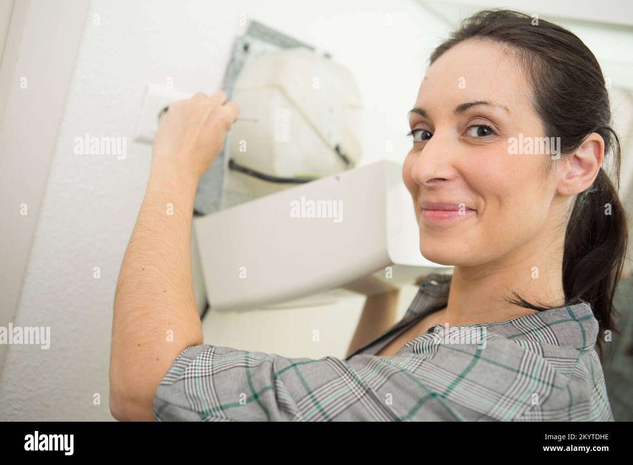 female worker fixing electrical issue with hand dryer Stock Photo Alamy