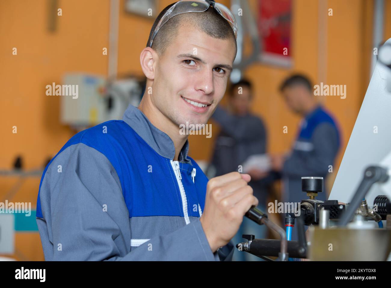 Quality Engineering Apprentice an apprentice checks component quality Stock Photo - Alamy