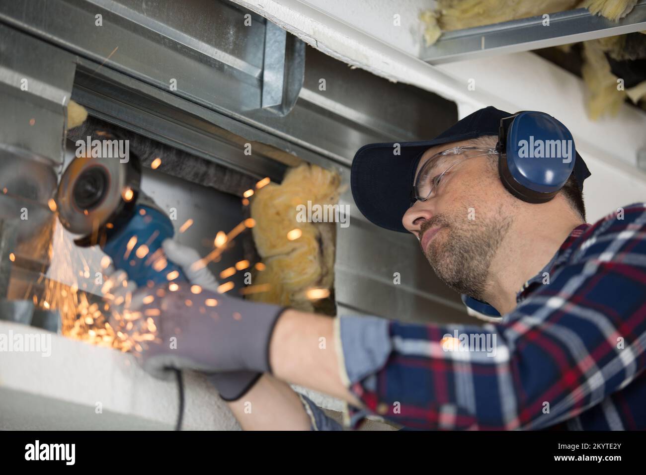 a window fitter using a disc cutter on brickwork Stock Photo Alamy