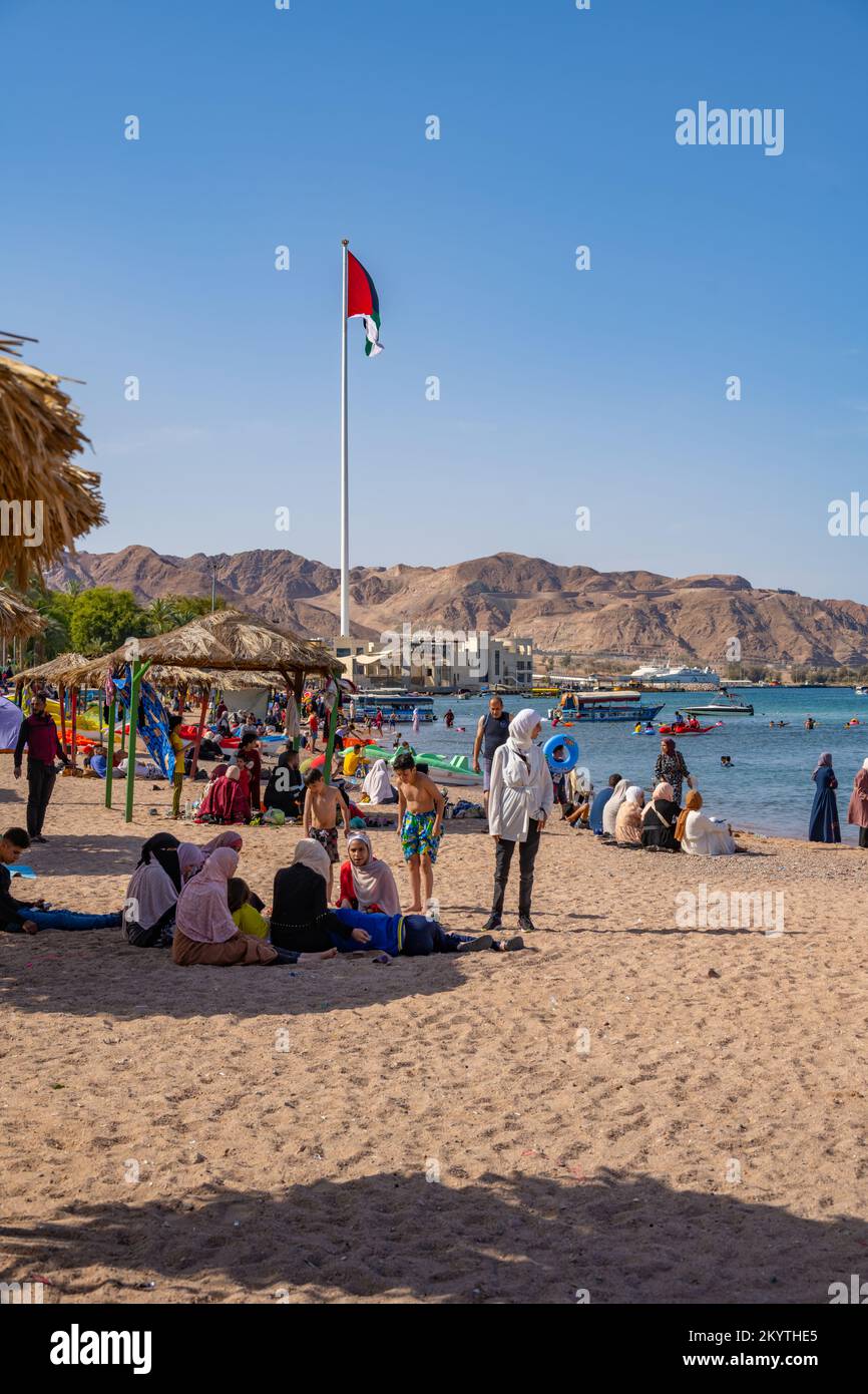 Al-Ghandour Beach in Aqaba Jordan looking South with the flag and flagpole commemorating the Arab Revolt Stock Photo