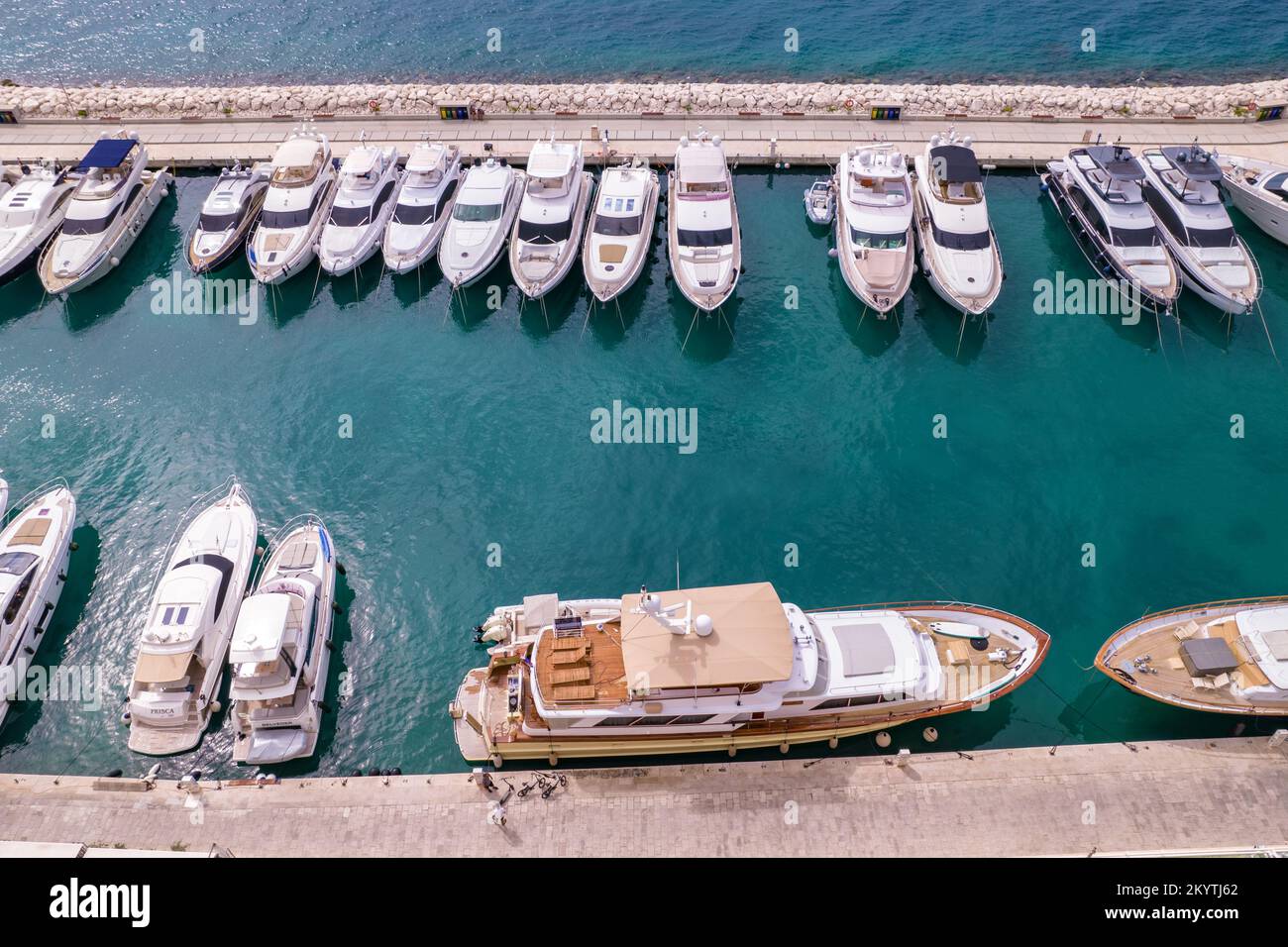 The aerial view on croatian beach and yachts pier in Adriatic sea. Marina Lav hotel and embankment near it. Boats and yachts staying in the bay. Stock Photo