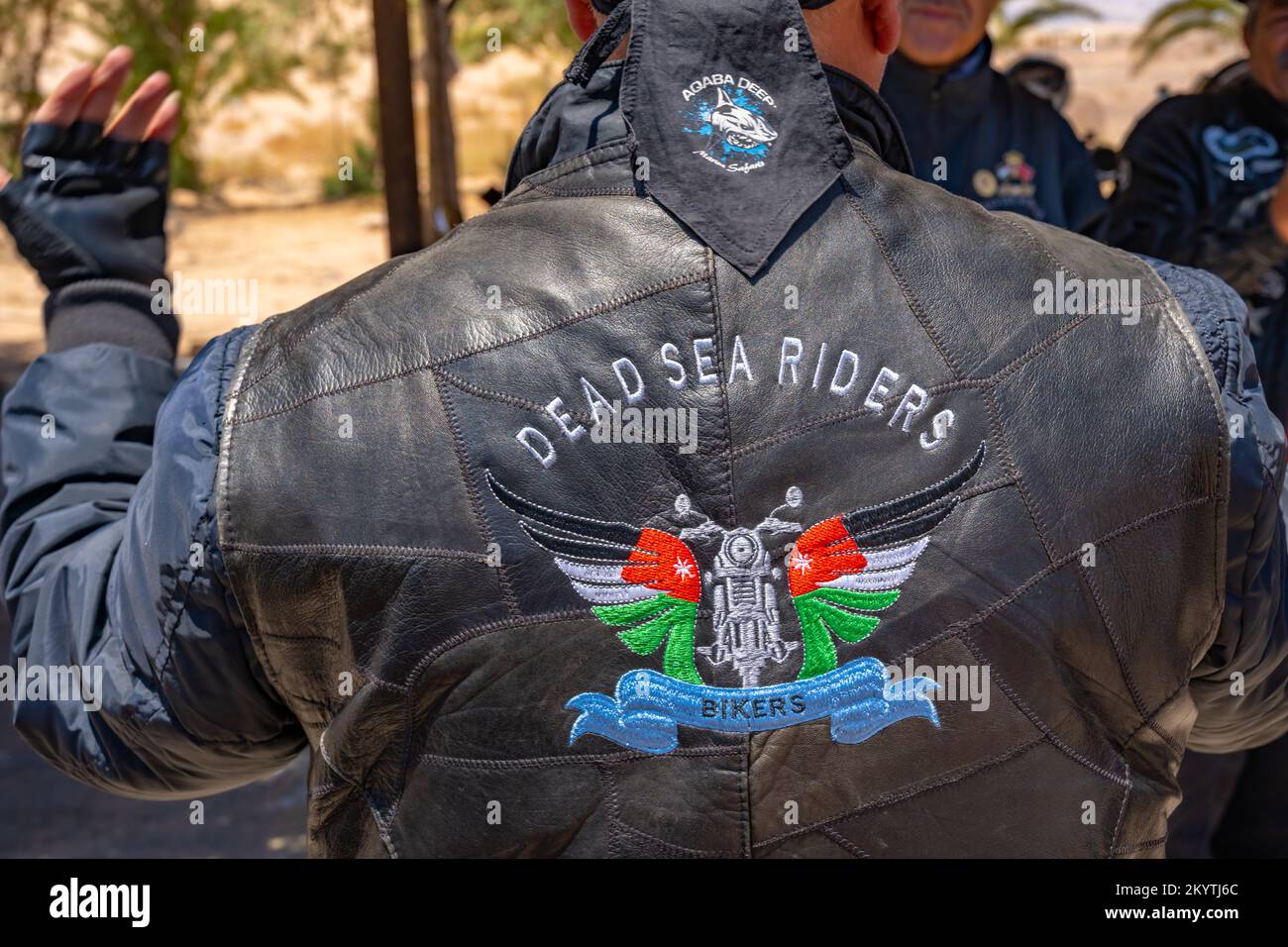 Back of the leather jacket of a motorbiker at a Service station on route 65 between Aqaba and the Dead Sea Stock Photo