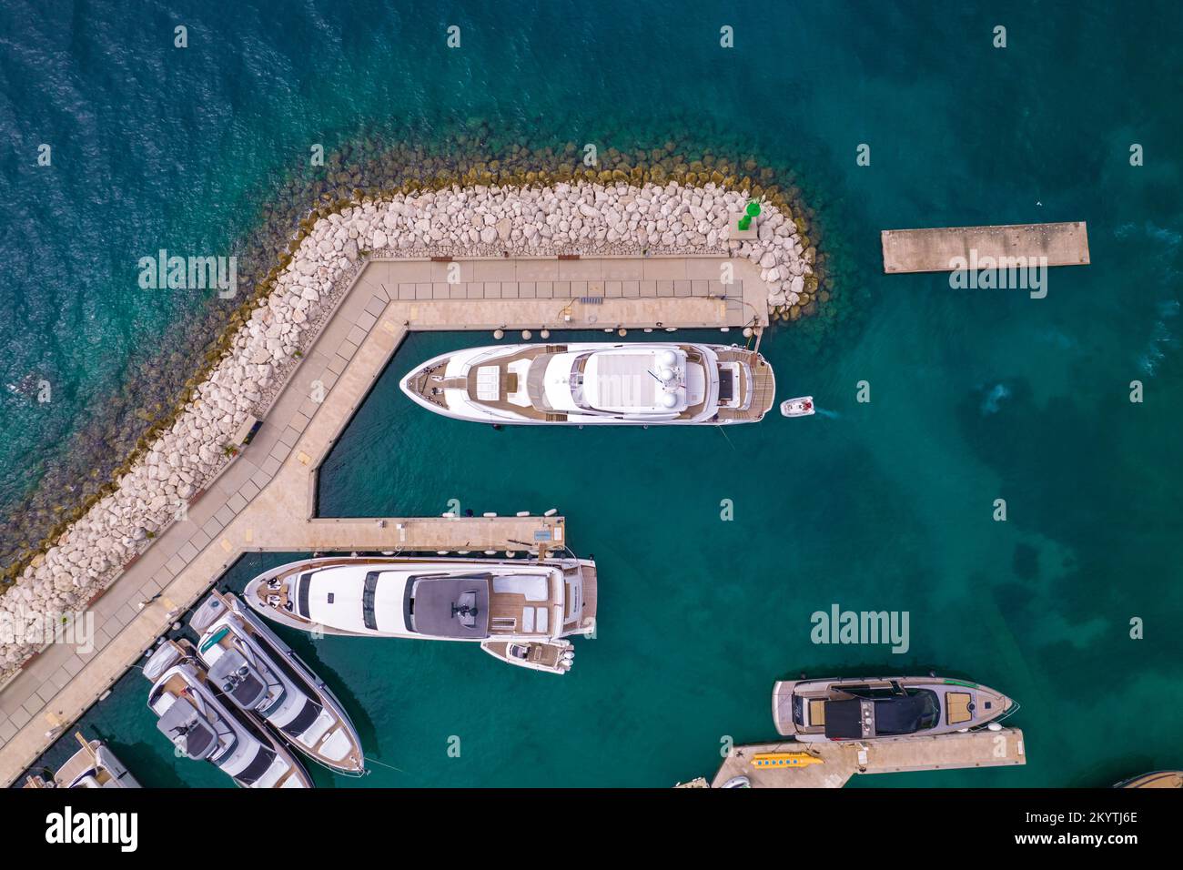 The aerial view on croatian beach and yachts pier in Adriatic sea. Marina Lav hotel and embankment near it. Boats and yachts staying in the bay. Stock Photo