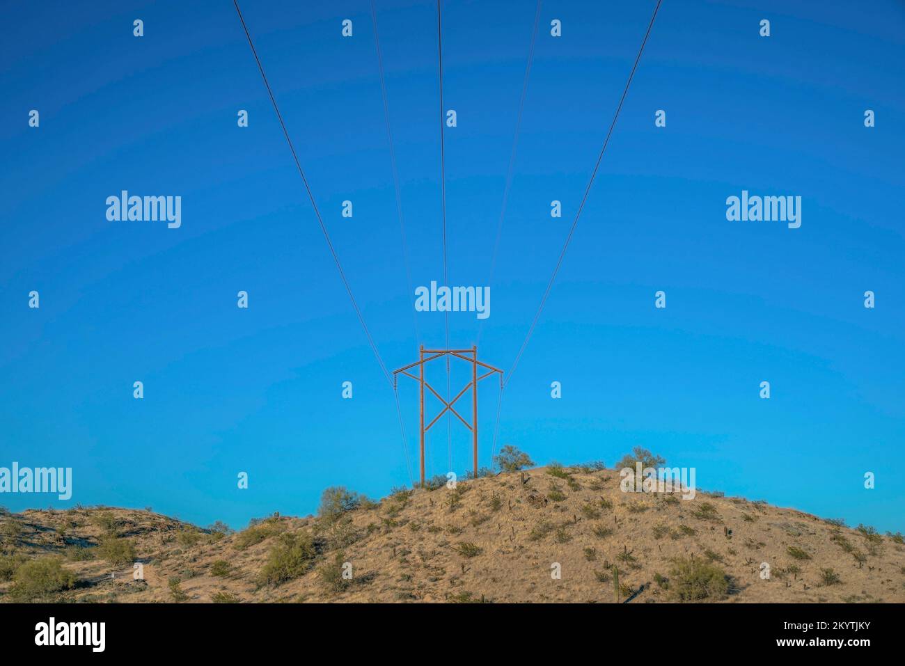 Phoenix, Arizona Transmission tower at Pima Canyon hiking trail. There is a slope with shrubs