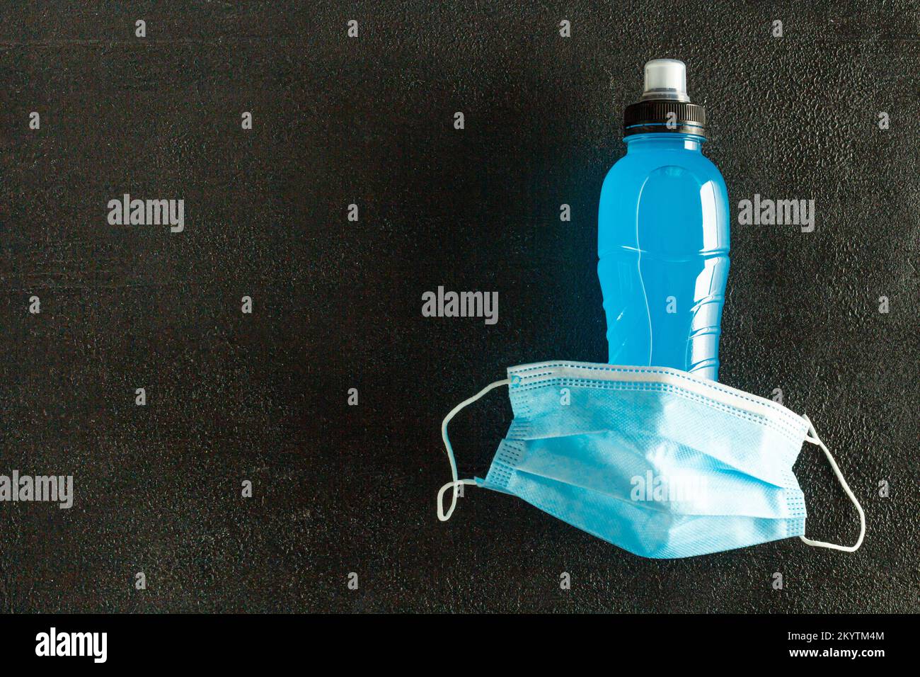 a bottle of isotonic energy drink on a dark background, a drink that