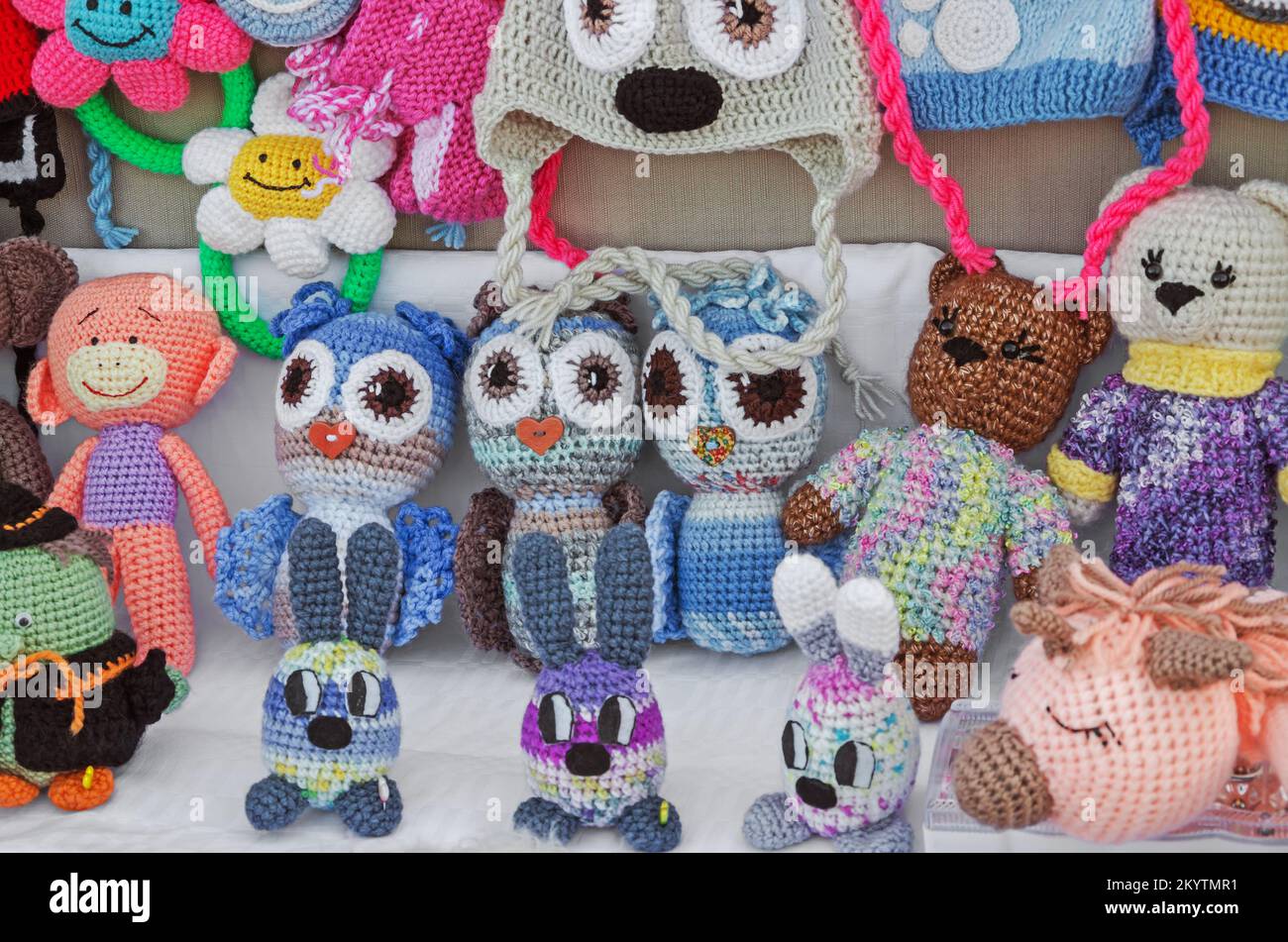 Set of childrens homemade hand knitted products toys and hats handicraft in form of funny little animals Stock Photo