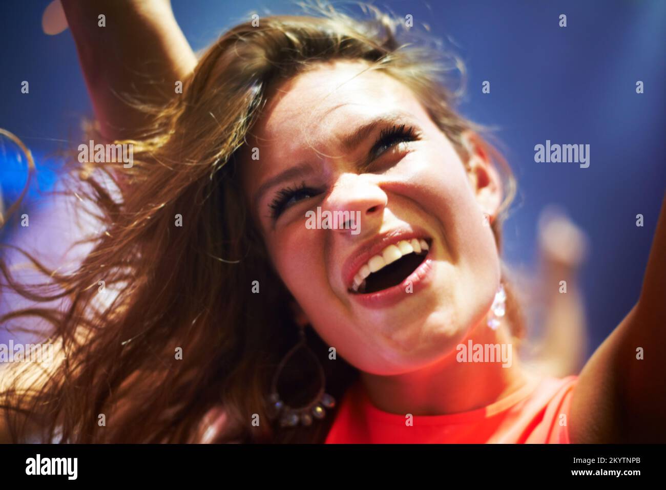 Dance, music and happy with woman at concert for party, nightclub and festival dj event. Disco, rock and freedom with girl dancing in crowd of fans Stock Photo