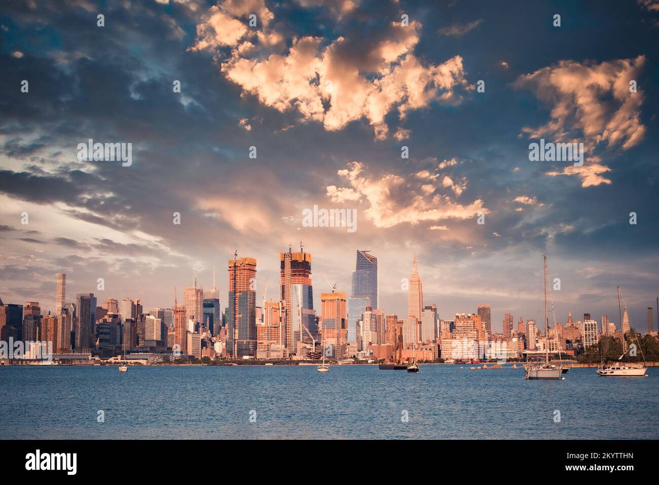 New York City skyline with skyscrapers, new construction, Hudson River  and sunset as seen from New Jersey Stock Photo