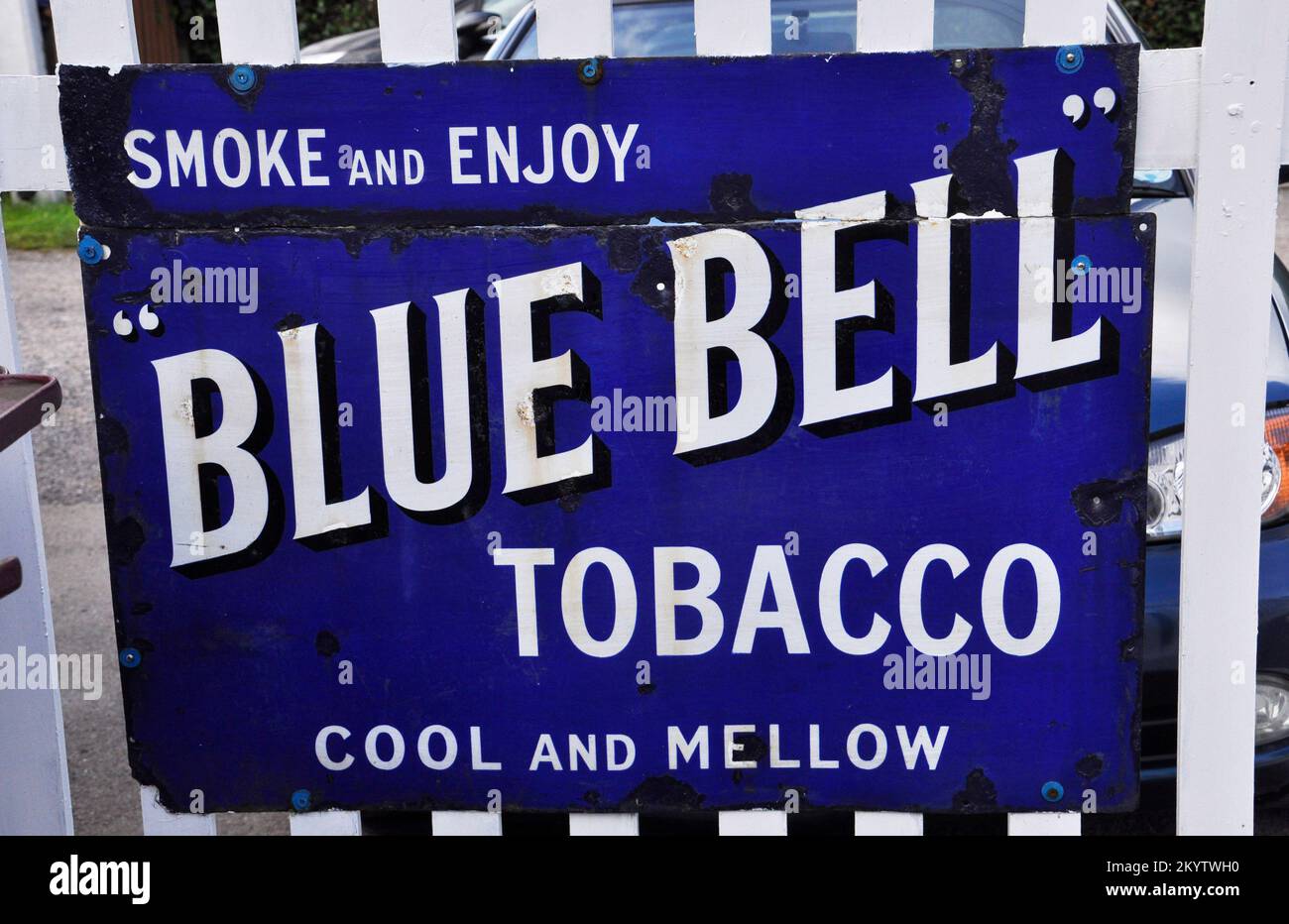 Enamelled metal sign, advertising 'Blue Bell' tobacco photographed at Bishops Lydeard station on the West Somerset railway in Somerset,England, UK Stock Photo