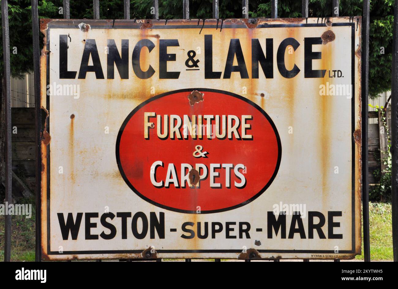 Enamelled metal sign, advertising Lance & Lance Furniture & Carpets photographed at Bishops Lydeard station on the West Somerset railway in Somerset,E Stock Photo