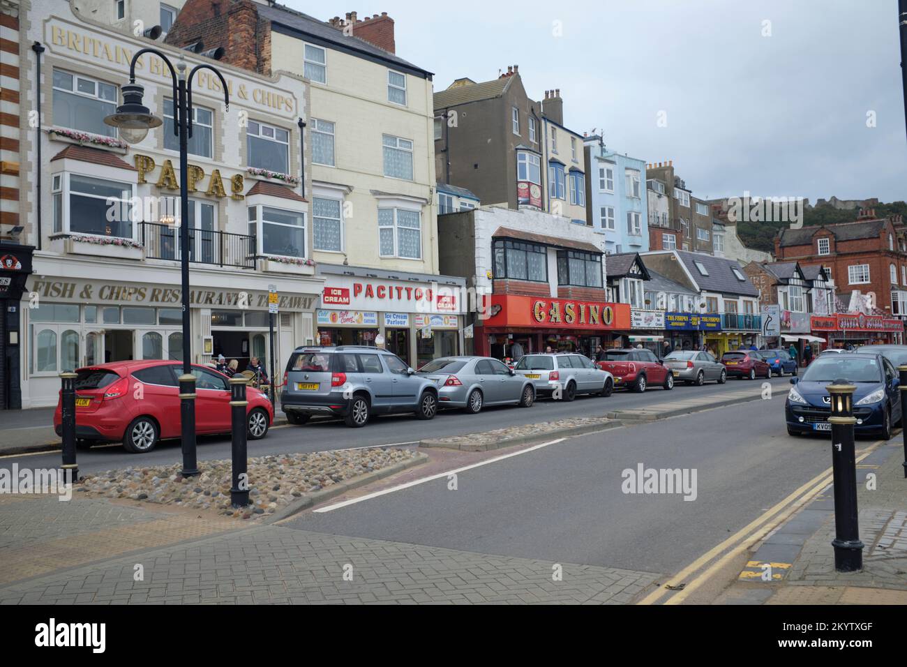Shops and parked cars along the Foreshore Road sea front at Scarborough