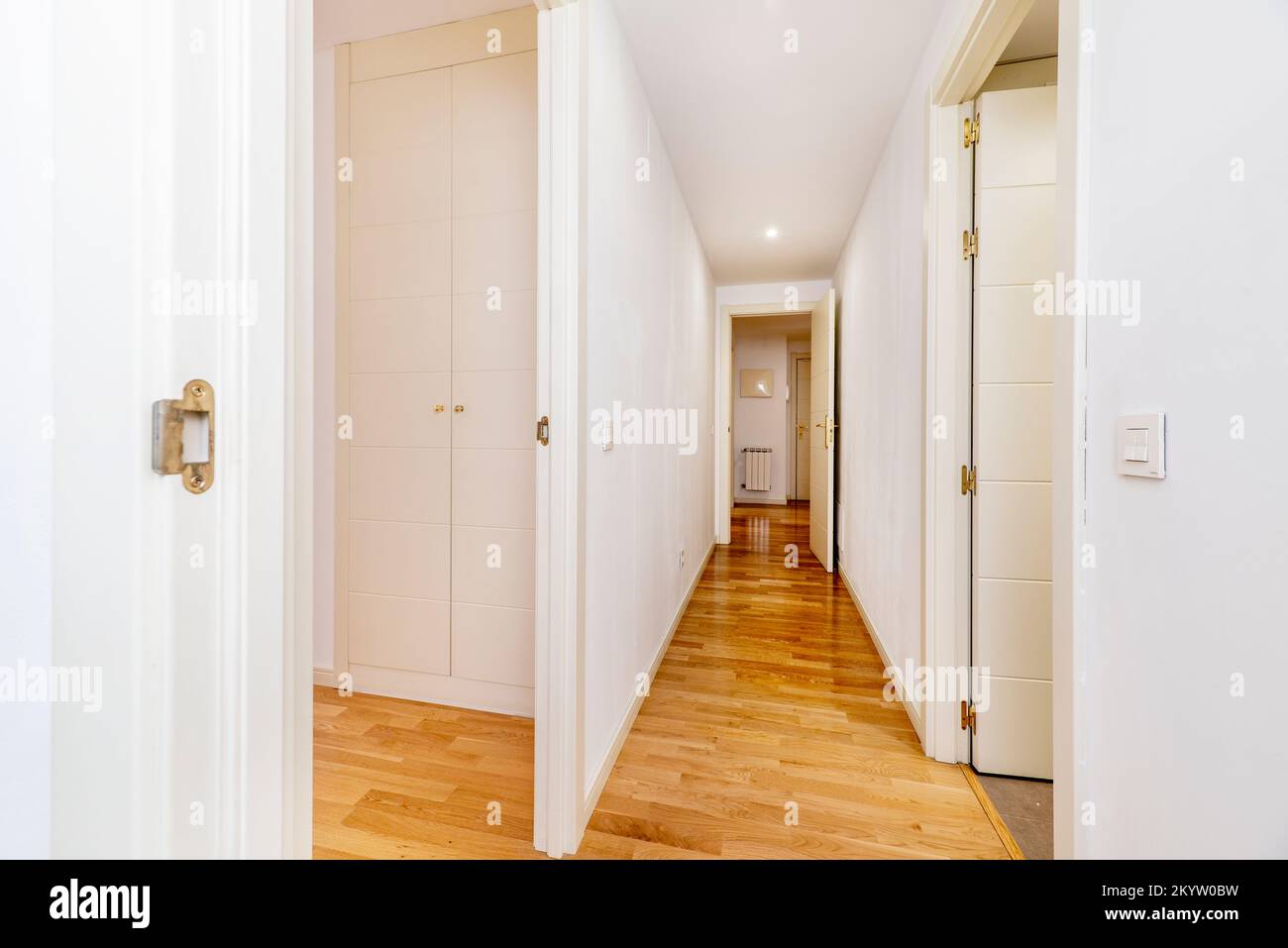 Housing distributor corridor with French oak parquet flooring and white