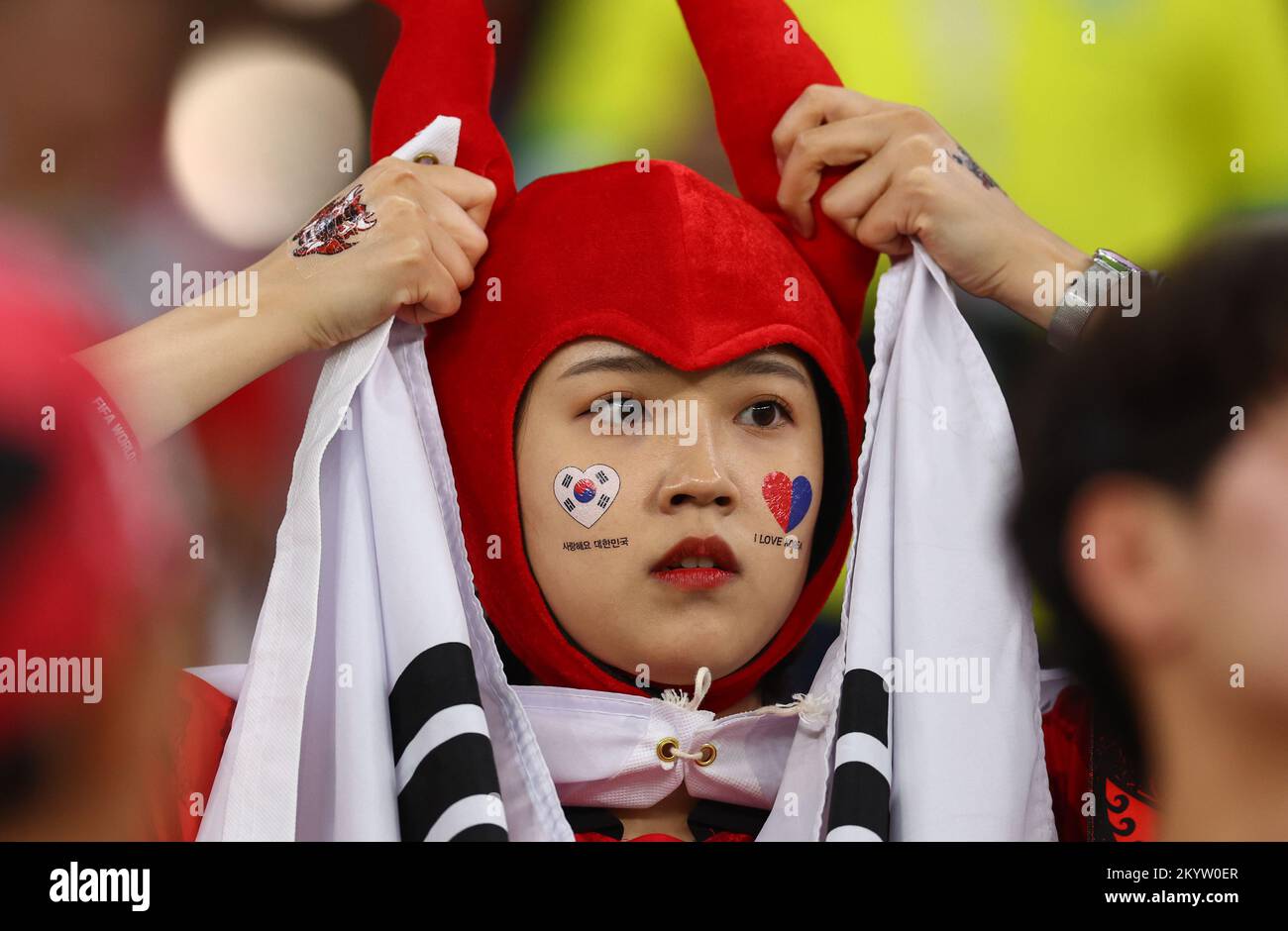A South Korea fan reacts as she watches the Qatar 2022 World Cup