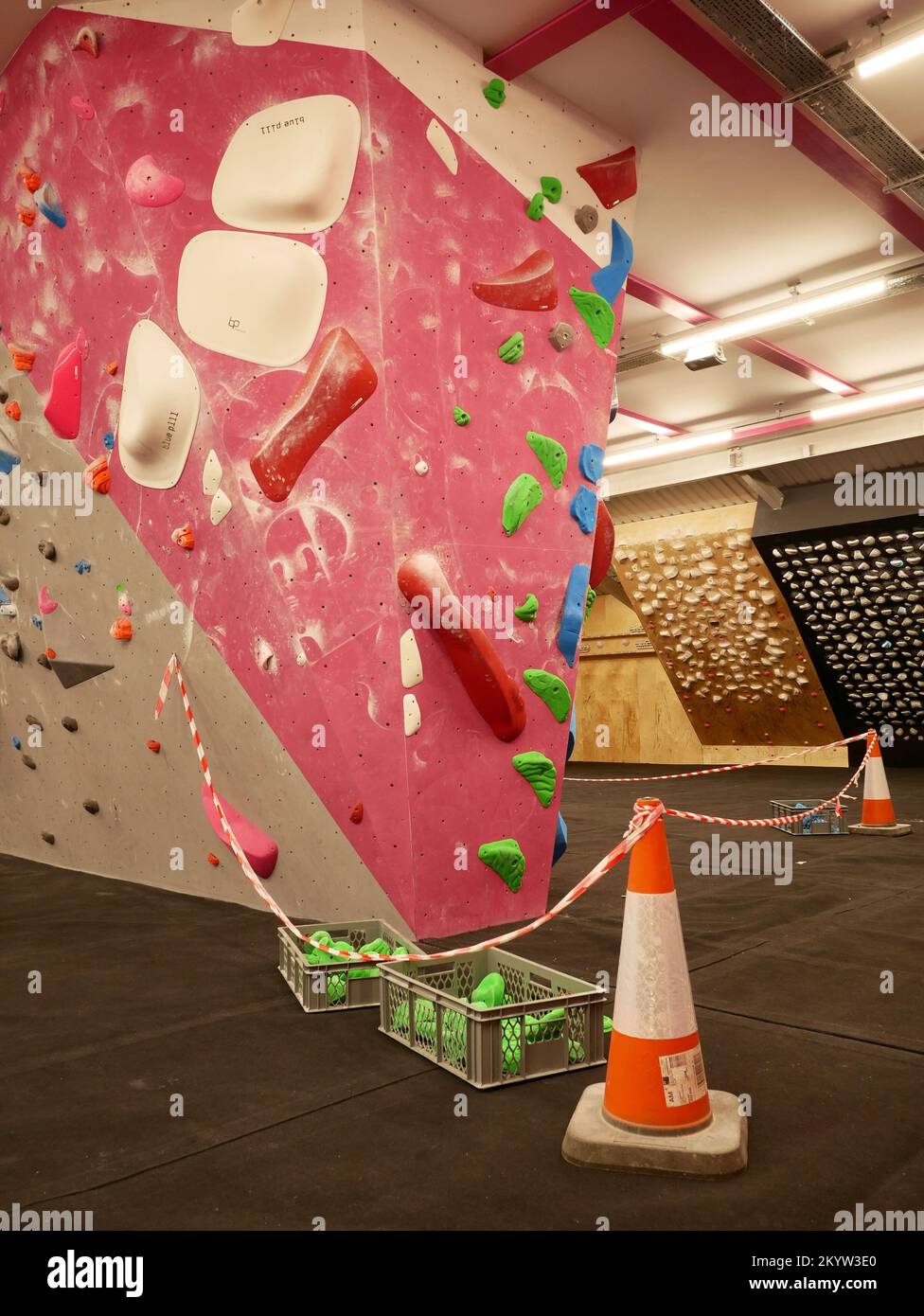 Climbing bouldering indoor gym with sections of wall closed during new route setting work. A route in bouldering is referred to as a problem. Stock Photo