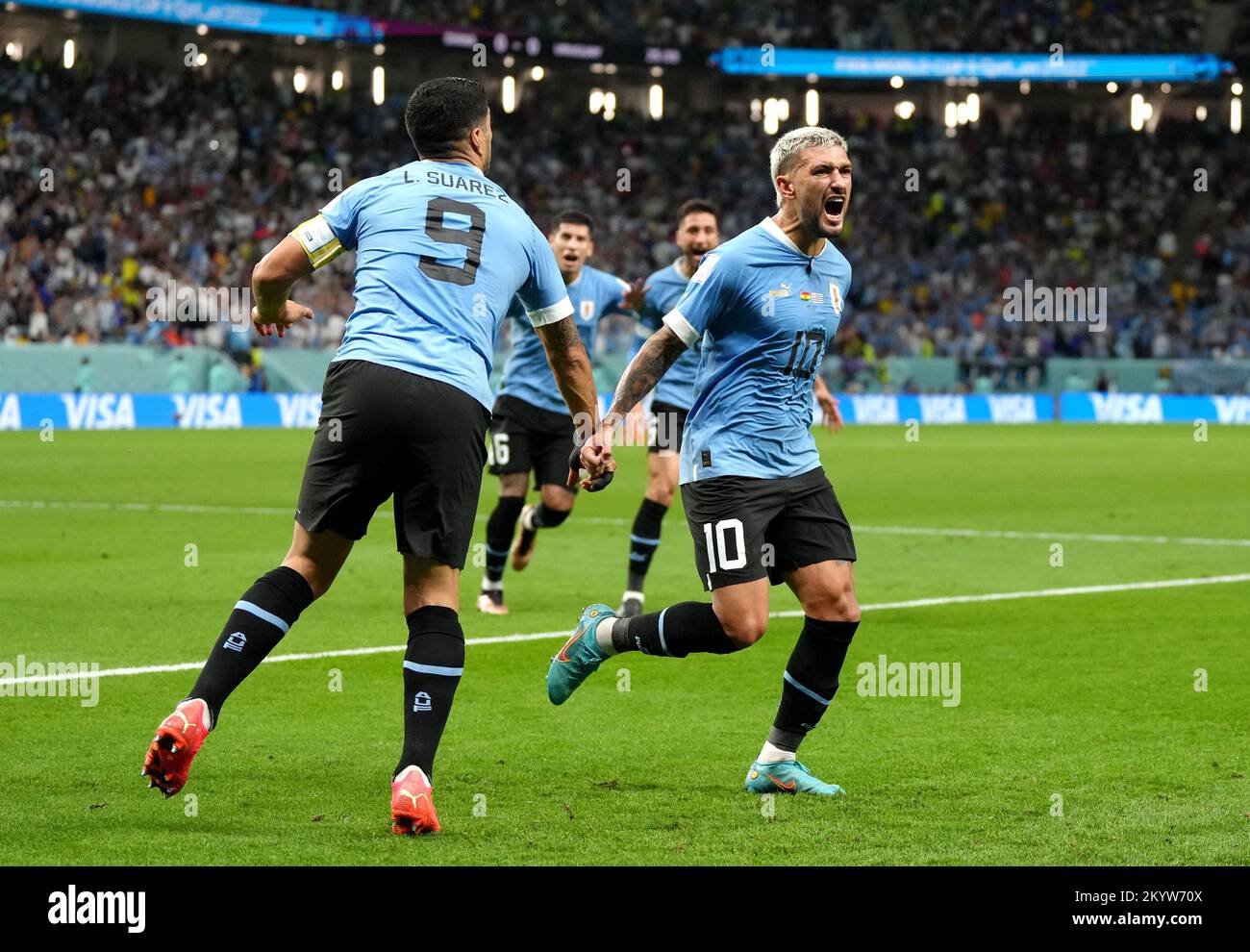 Uruguay's Giorgian de Arrascaeta (right) celebrates scoring their side's first goal of the game with teammate Luis Suarez during the FIFA World Cup Group H match at the Al Janoub Stadium in Al-Wakrah, Qatar. Picture date: Friday December 2, 2022. Stock Photo