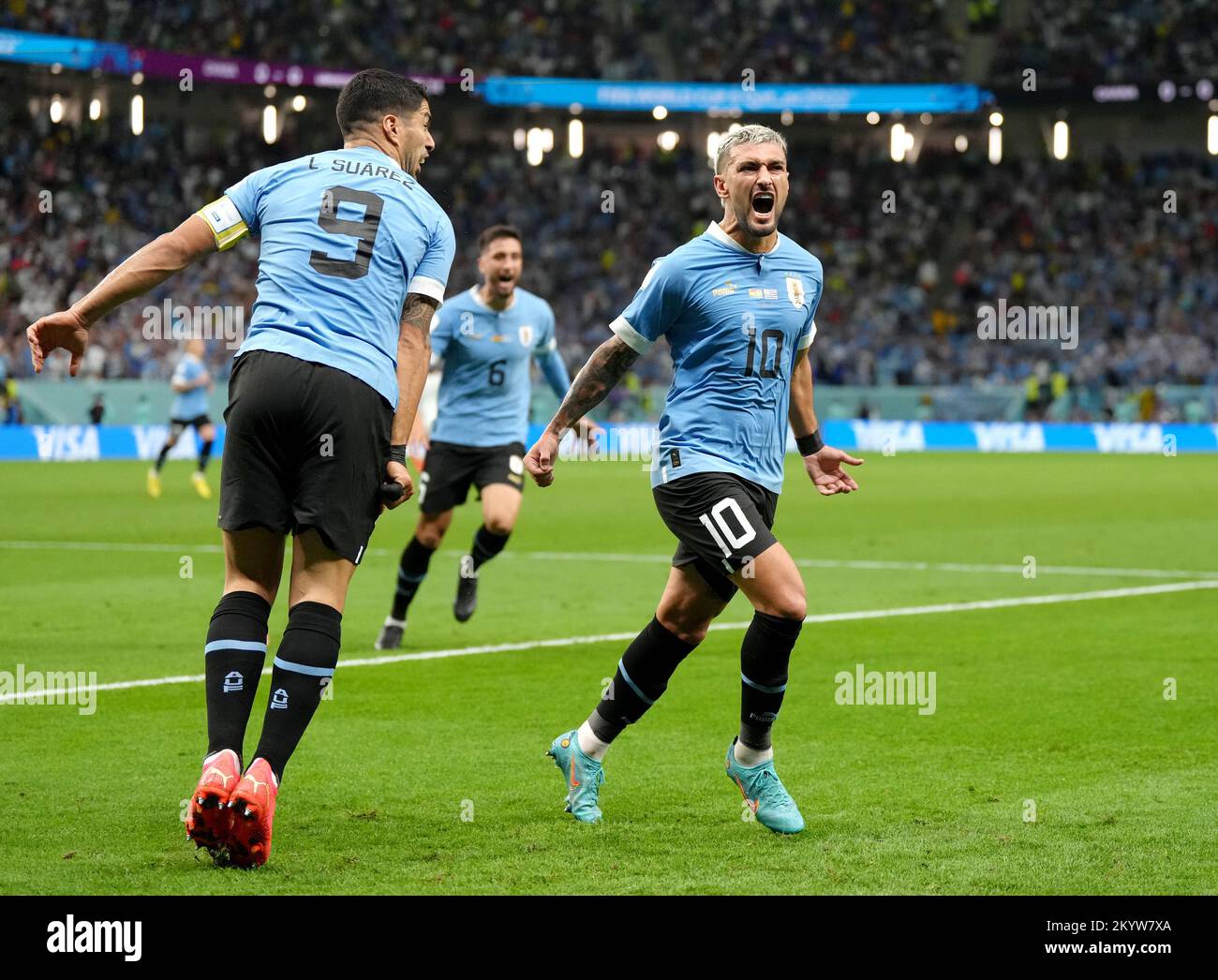 Uruguay's Giorgian de Arrascaeta (right) celebrates scoring their side's second goal of the game with teammate Luis Suarez during the FIFA World Cup Group H match at the Al Janoub Stadium in Al-Wakrah, Qatar. Picture date: Friday December 2, 2022. Stock Photo