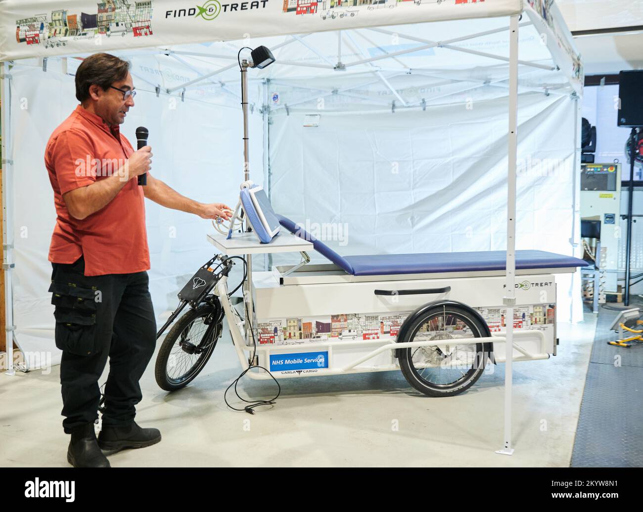 Berlin, Germany. 02nd Dec, 2022. Indrajit Ghosh, a doctor in London, presents the 'First Hospital on a Cargo Bike' at MotionLab. The English health system NHS gave the order to Velofracht, a German company that designs and manufactures load carriers. It is also intended to help homeless people in particular and can read lab swabs in a short time. Credit: Annette Riedl/dpa/Alamy Live News Stock Photo