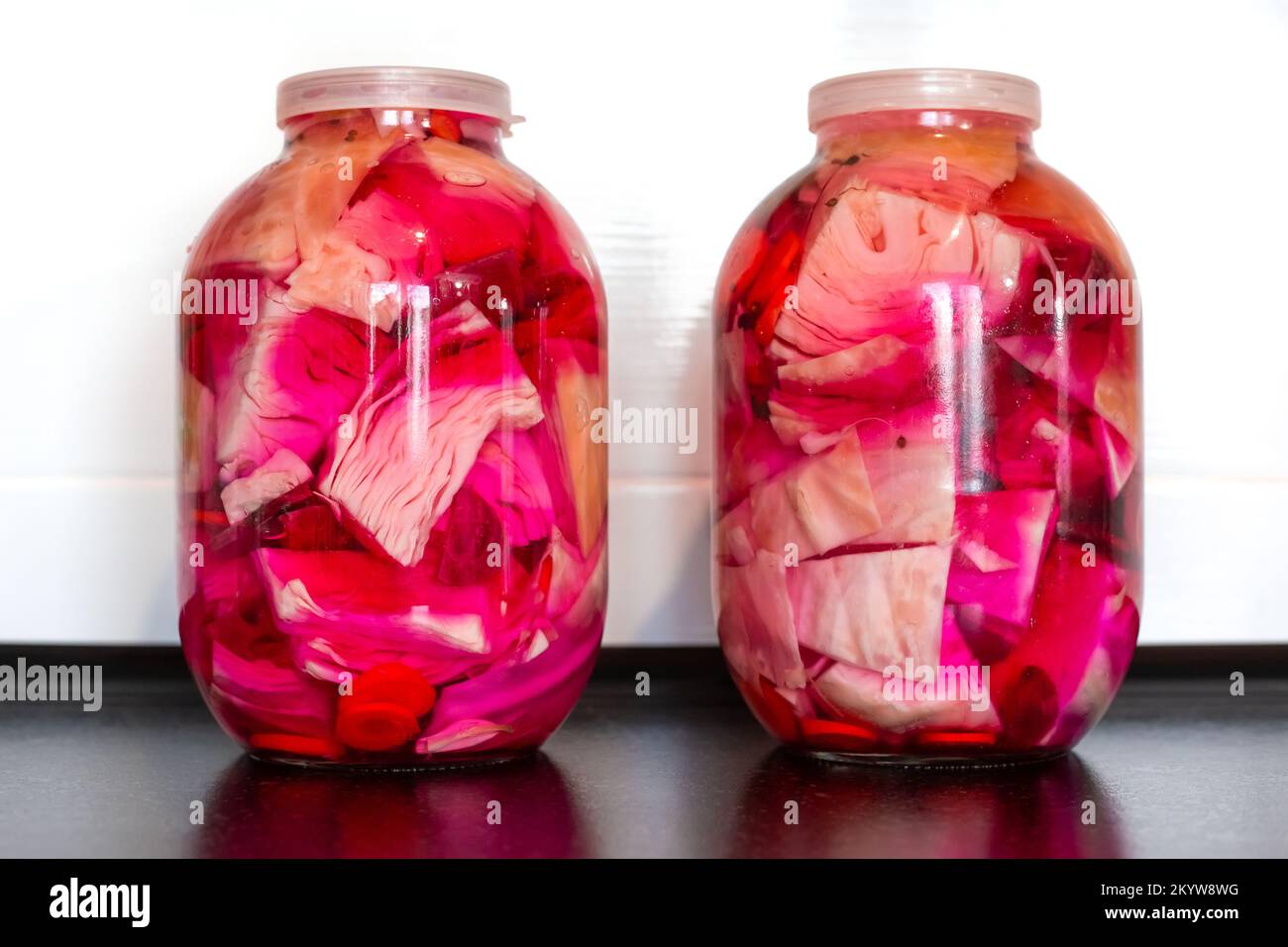 canned white cabbage with beets in glass jars. Salting and pickling