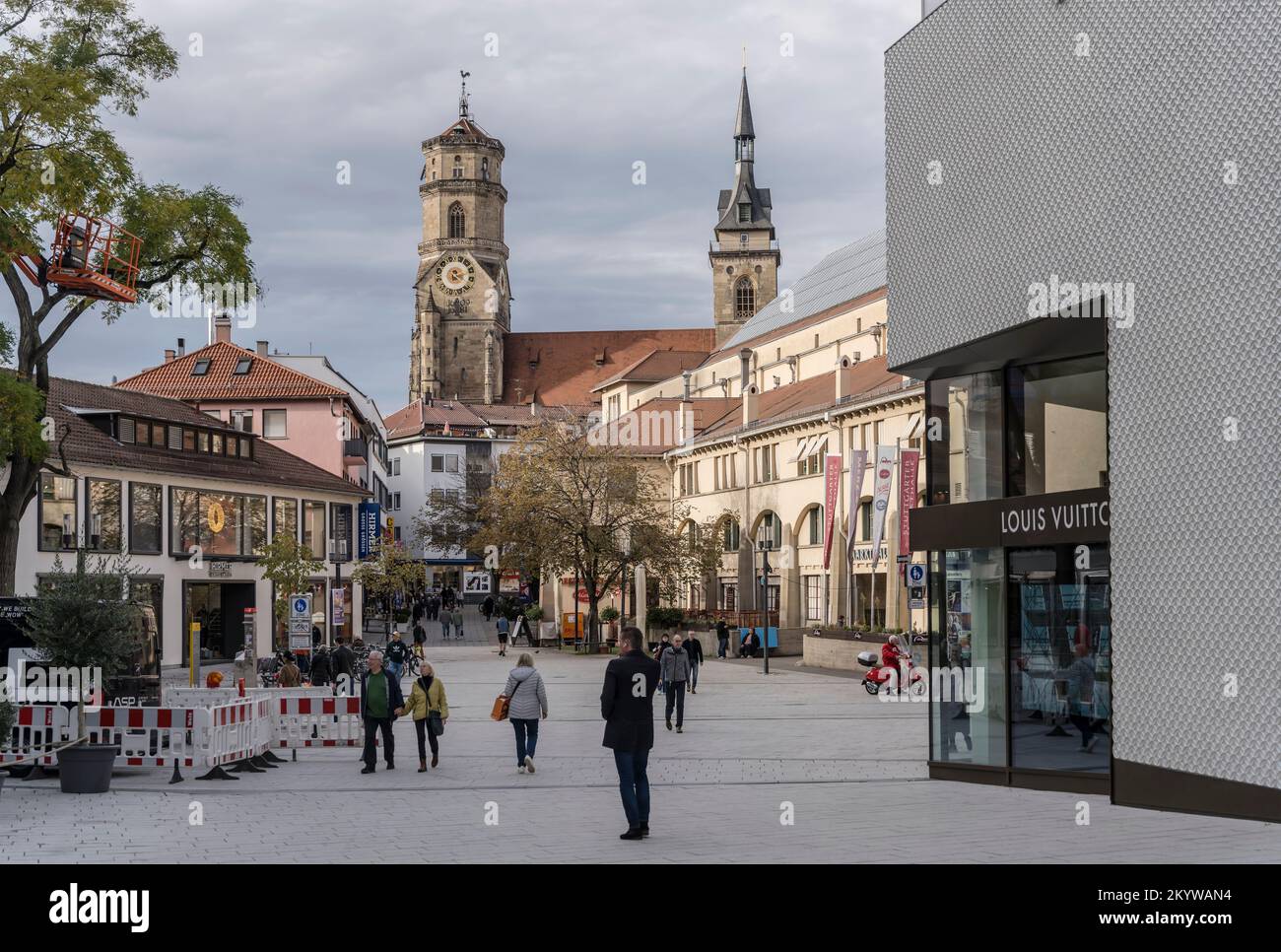STUTTGART, 2022 november 08; cityscape with  Stiftskirche church huge bell towers loomig out of old buildings on pedetrian precinct, shot in bright fa Stock Photo