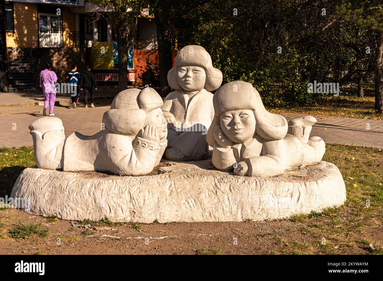 Kazakhstan urban sculpture - three Kazakh children in winter clothes. Karaganda, Kazakhstan Stock Photo