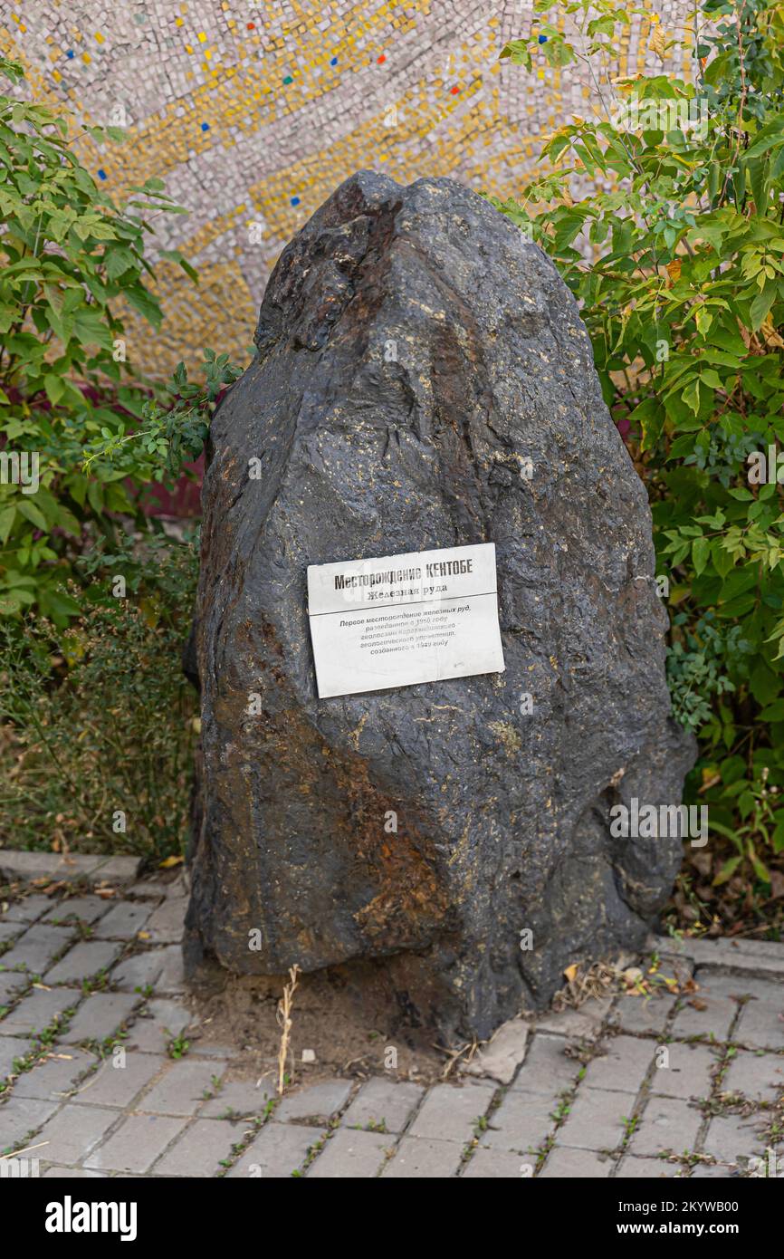 The Kentobe iron ore example. Piece of iron ore with plaque commemorating first iron ore mine in Kazakhstan opened in 1949 by Kazakh geologists. Stock Photo