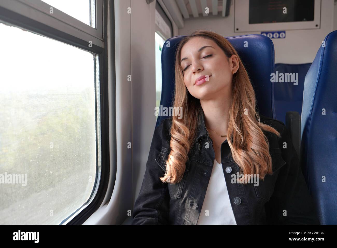 Beautiful woman sleeping sitting on public transport on autumn season Stock Photo