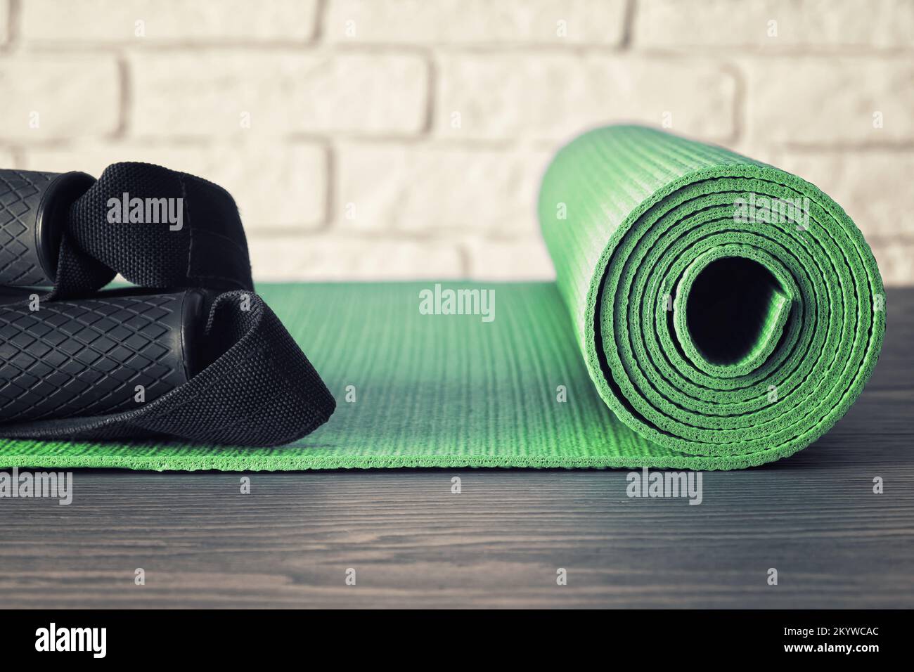 Green sports mat and rops for exercises in the fitness studio. Aerobic