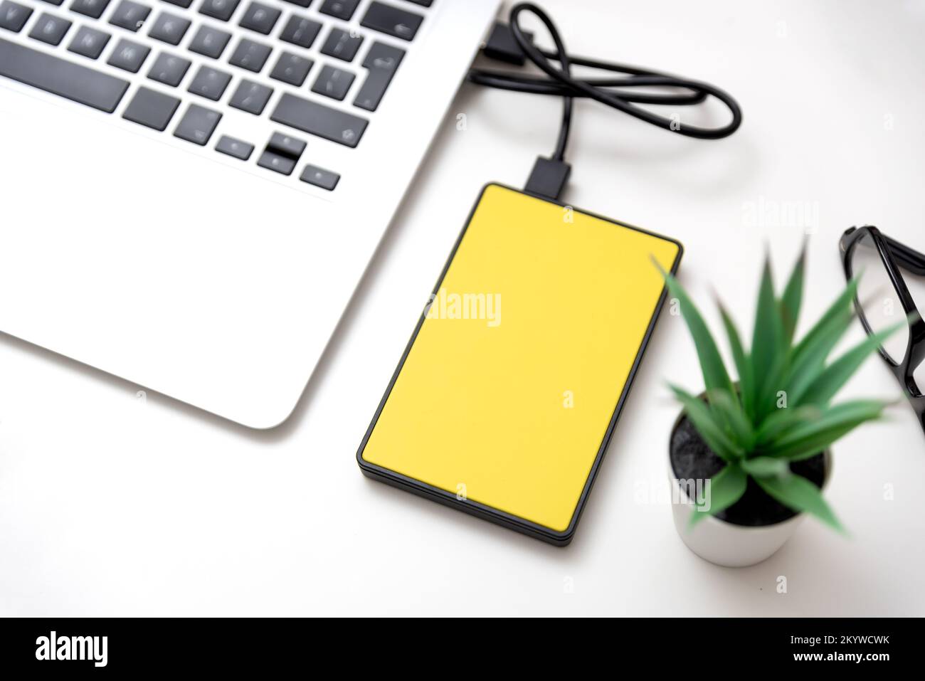 External hard disk connected to laptop. USB drive backup data Stock