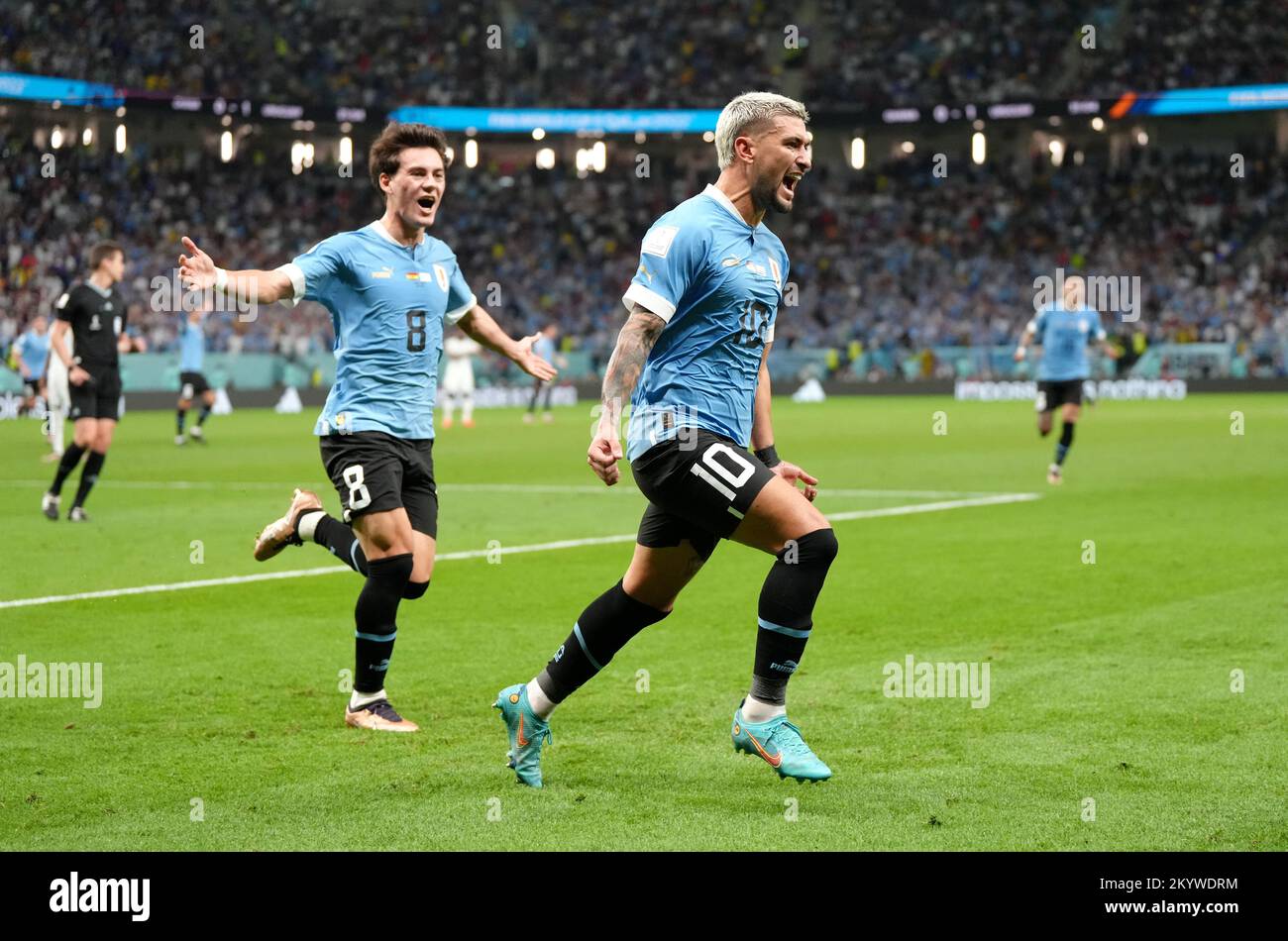 Uruguay's Giorgian de Arrascaeta celebrates scoring their side's second goal of the game with teammate Facundo Pellistri during the FIFA World Cup Group H match at the Al Janoub Stadium in Al-Wakrah, Qatar. Picture date: Friday December 2, 2022. Stock Photo