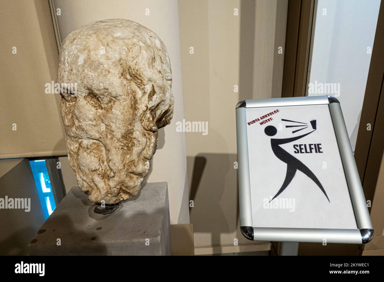 Poster enocouraging to take selfie in archaeological museum in Bursa. Old statue head with take selfie poster Stock Photo