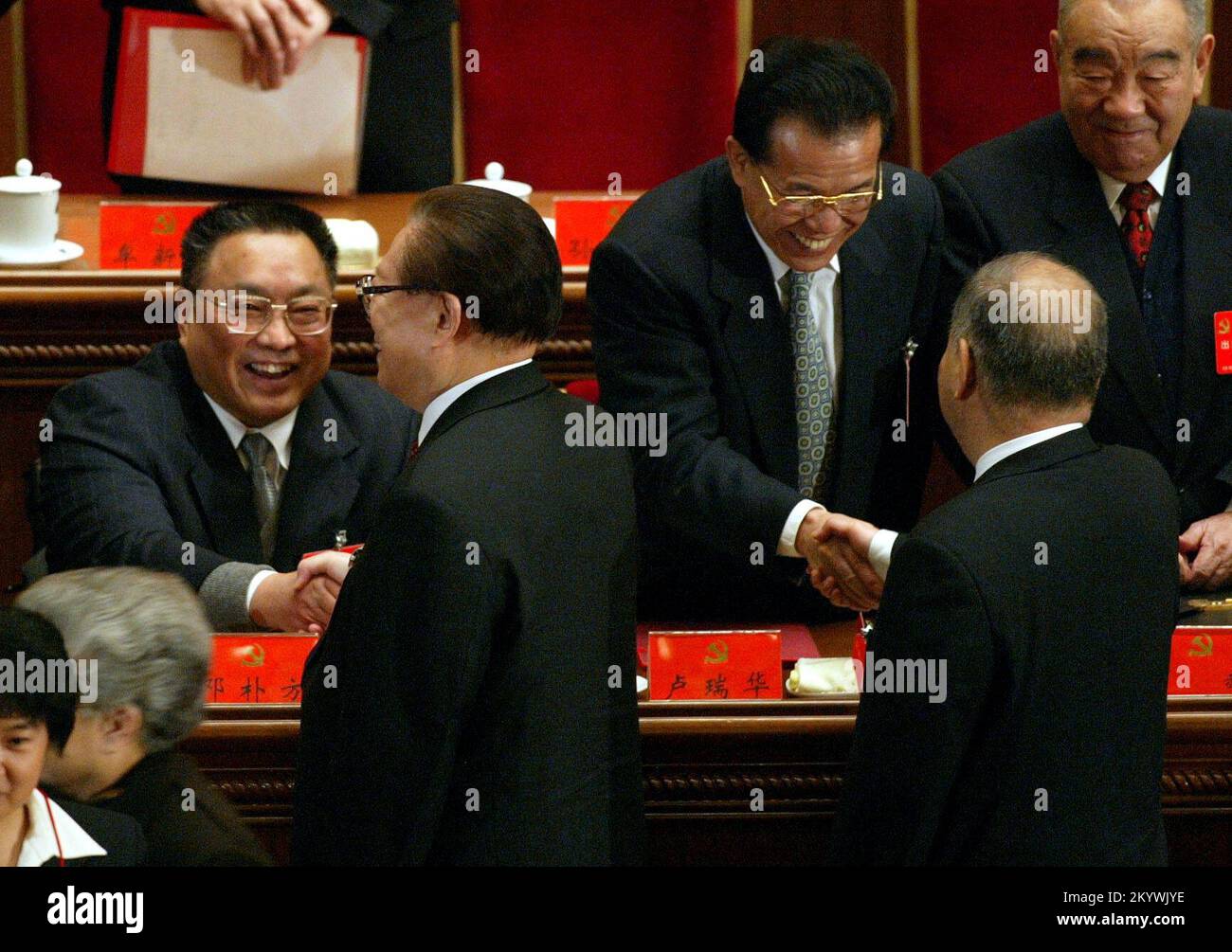 The Chinese President Jiang Zemin (2nd left) shakes hands with Deng Pufang (L), who is the son of late Deng Xiaoping, on the closing day of the China's 16th Communist Party Congress at the Great Hall of the People in Beijing, China. Mr Hu Jintao is expected to be elected the next Chinese President during this congress. 14 November 2002  ***NOT FOR ADVERTISING USE*** Stock Photo
