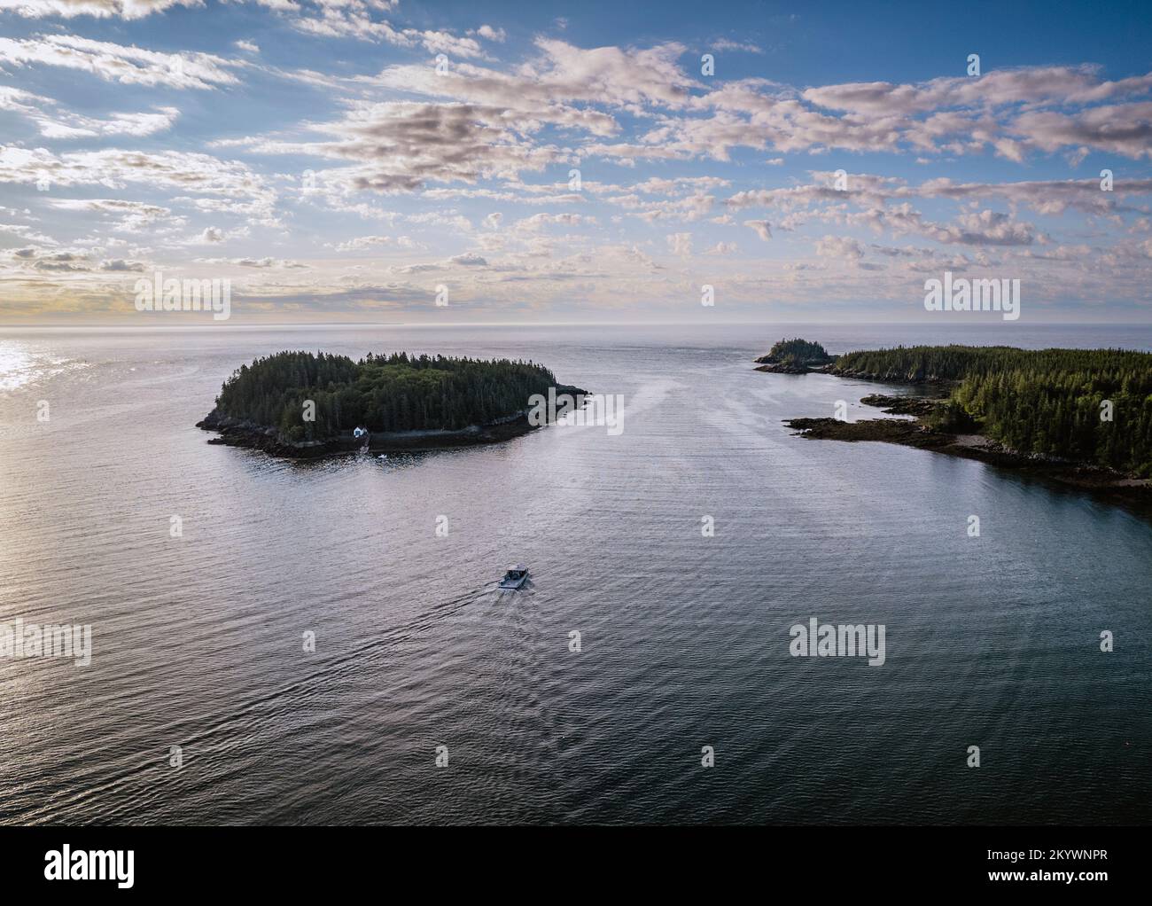 Aerial view of lobster boat heading to sea at sunrise, Cutler, Maine