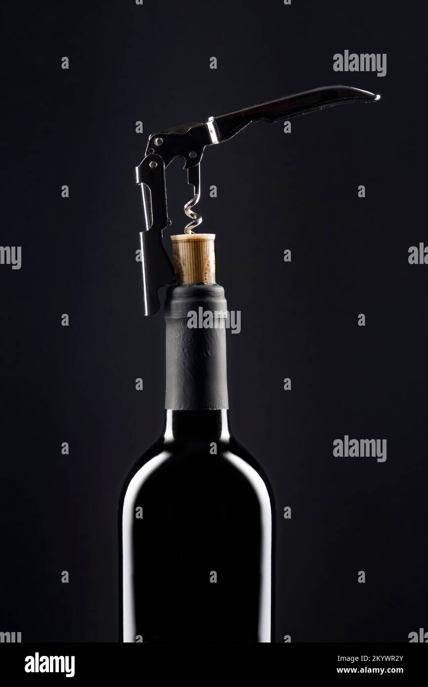 Corkscrew opening bottle of wine Stock Photo