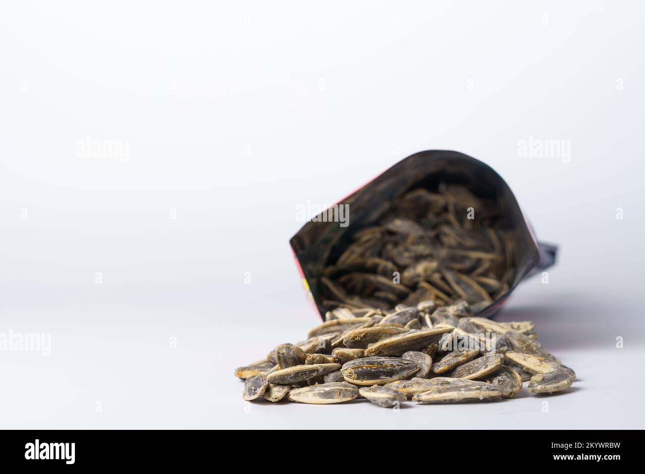 roasted sunflower seeds with salt coming out of their bag Stock Photo
