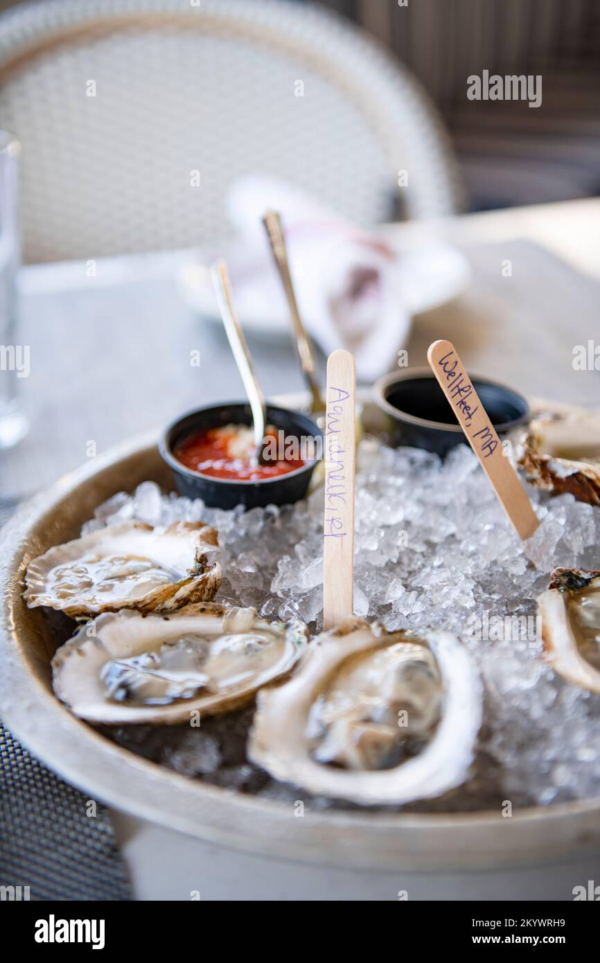 Oysters on the half shell marked with their farm location Stock Photo