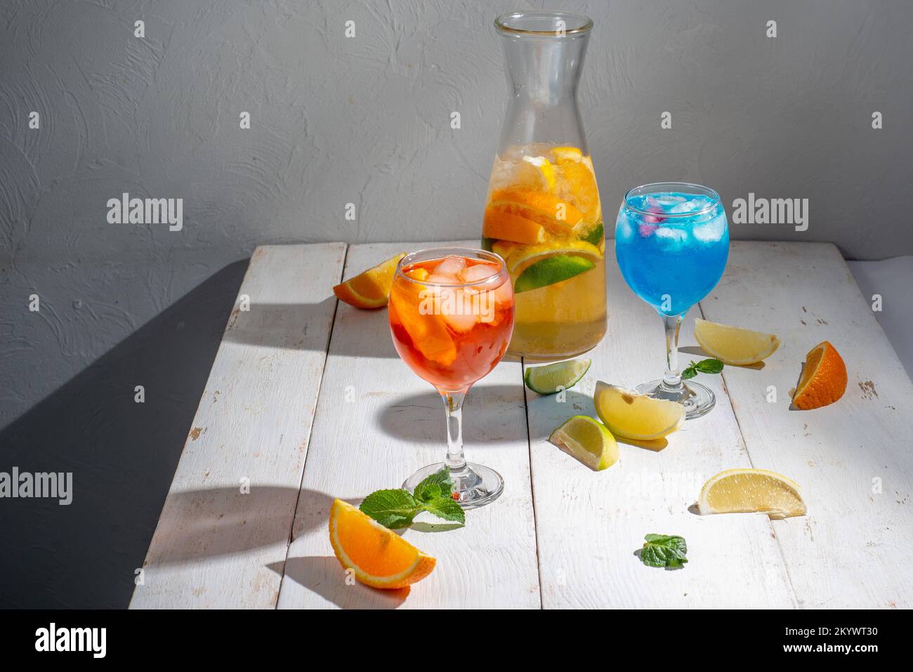 Many different cocktails on a light background. Mixology and nightlife concept. Colored alcoholic and non-alcoholic cocktails Stock Photo