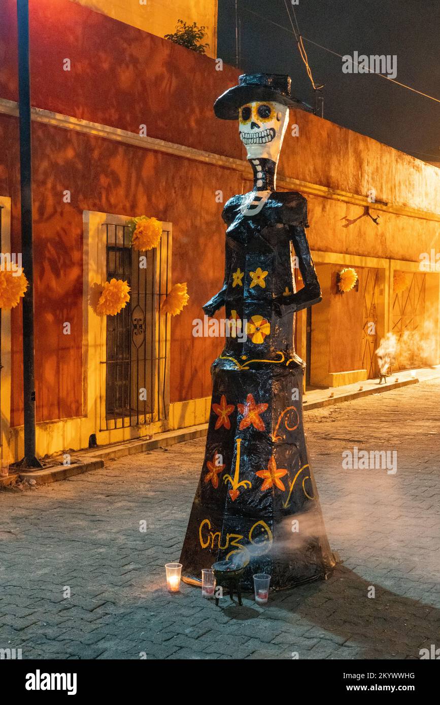 A large papier mache statue of La Catrina on the street of Xochimilco at night to celebrate Day of the Dead in Oaxaca, Mexico. Stock Photo