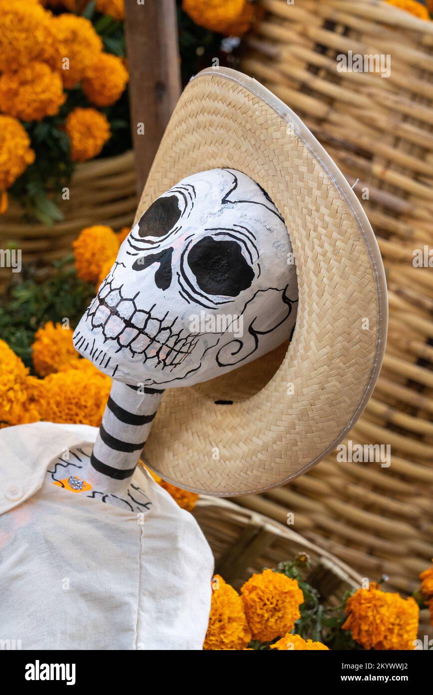 A papier mache mannequin dressed as a campesino with marigolds on the street for Day of the Dead in Oaxaca, Mexico. Stock Photo