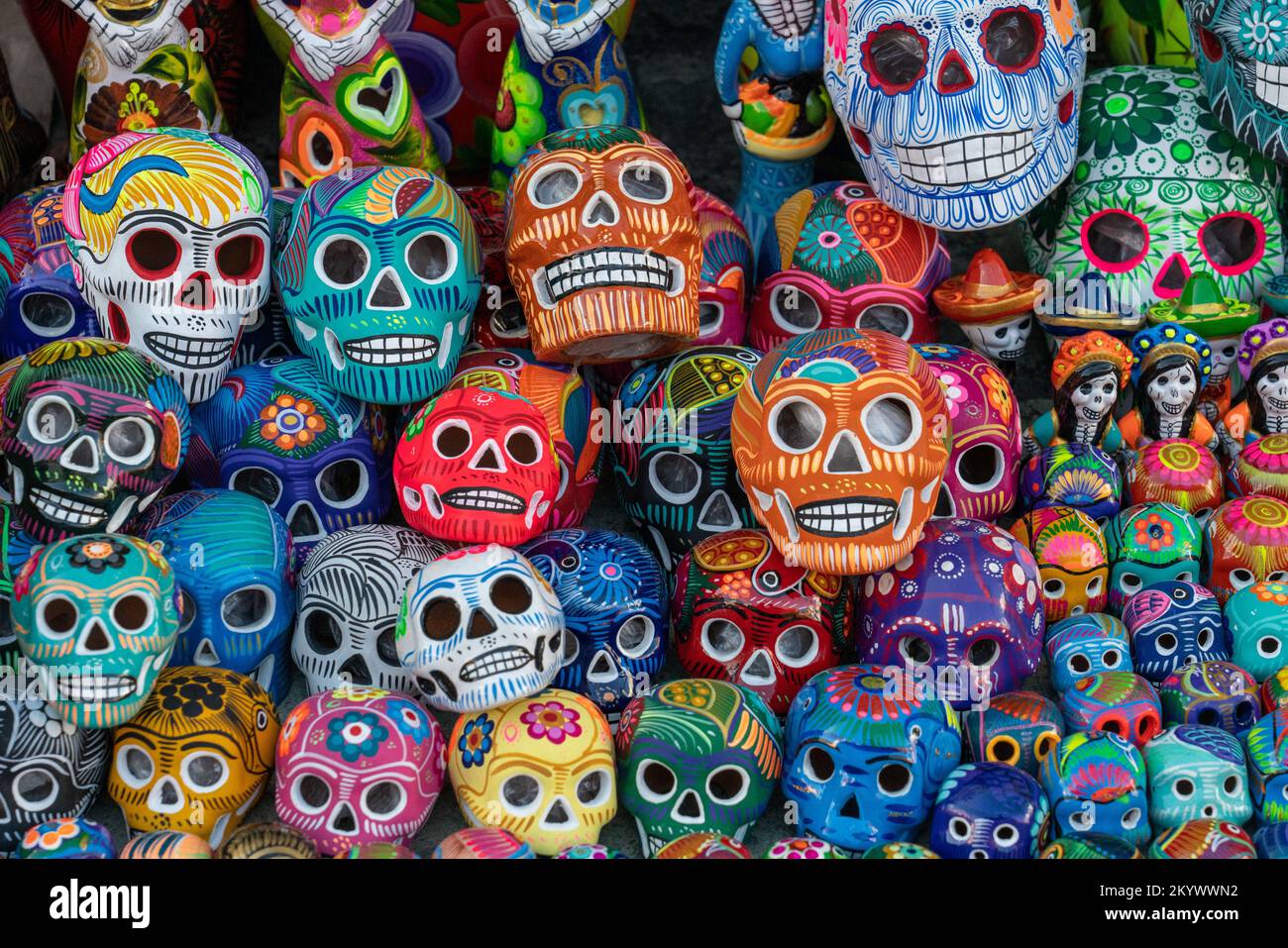 Colorful hand-painted ceramic skulls celebrating the Day of the Dead Fiesta for sale on the street in Oaxaca, Mexico. Stock Photo